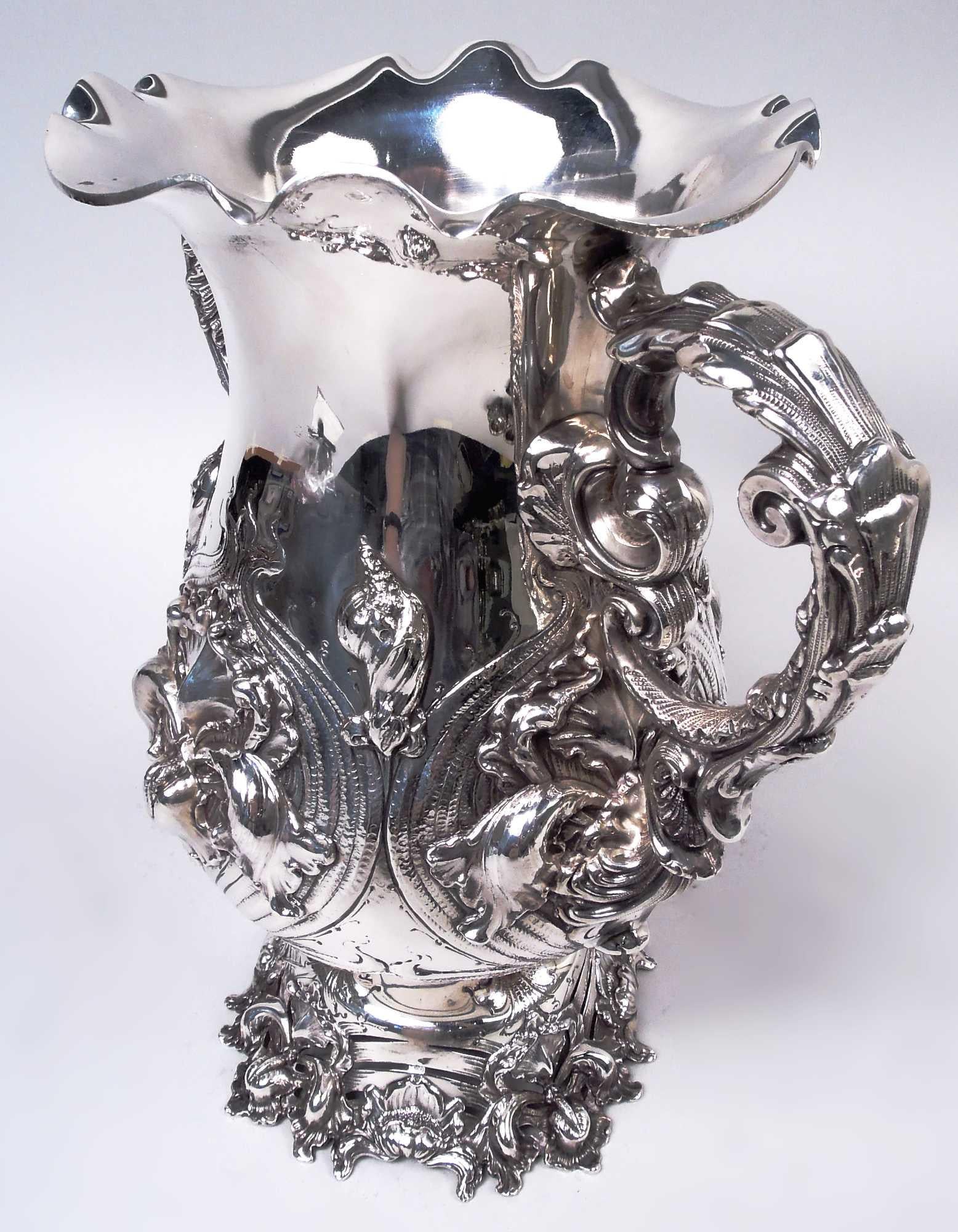 Art Nouveau sterling silver wine cooler. Made by George W. Shiebler & Co. in New York, ca 1890. Amphora with leaf-capped and wrapped double-scroll side handles; wavy mouth rim and domed foot. Classical form with advanced ornament: Cast iris flowers