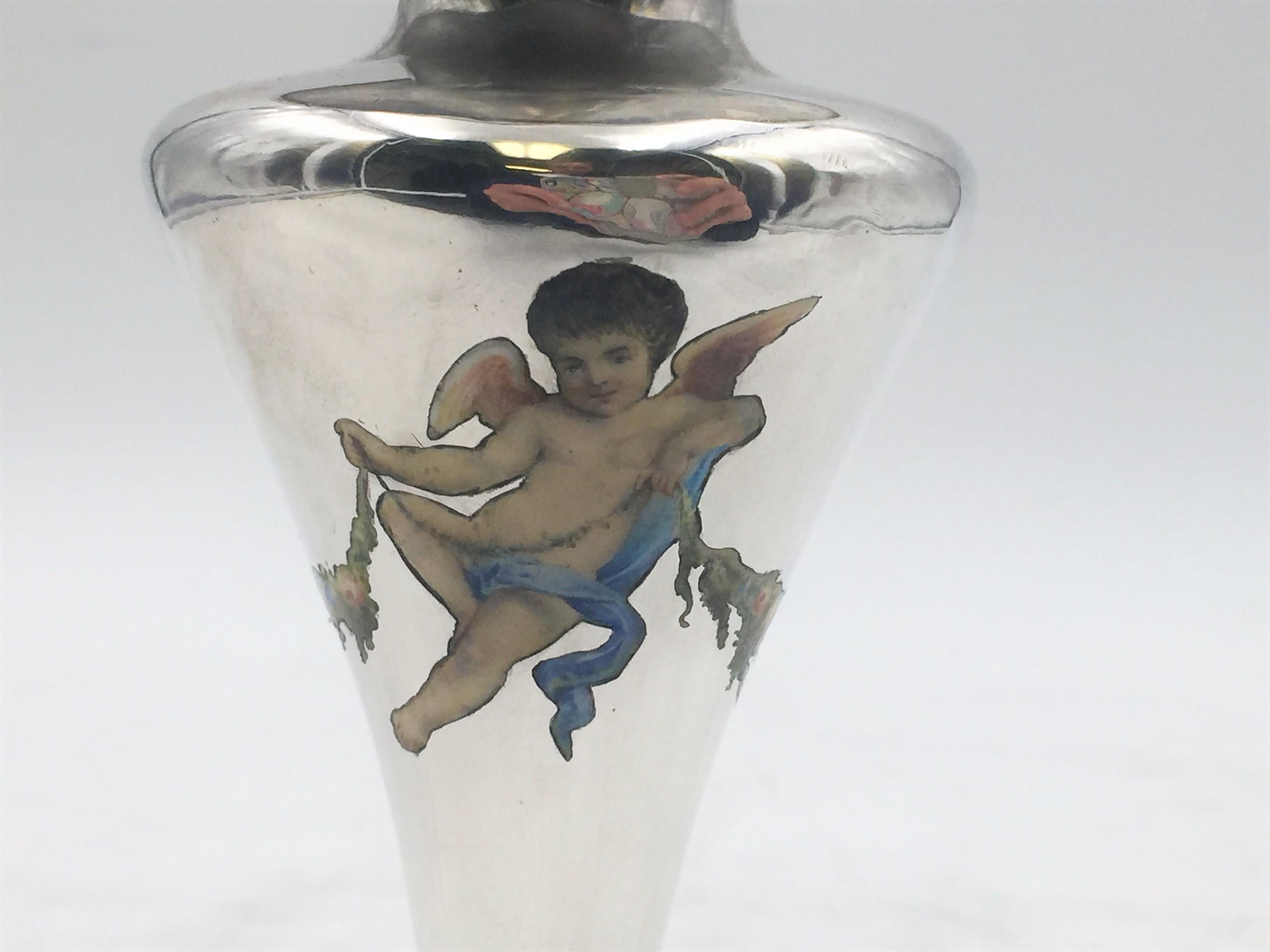 Sterling silver vase with enamel putti and floral decoration on the body and at the base by Shiebler, from the late 19th/ early 20th century, measuring 6'' in height by 2 3/4'' in diameter at the base, and weighing 5.5 ozt. Bearing hallmarks as