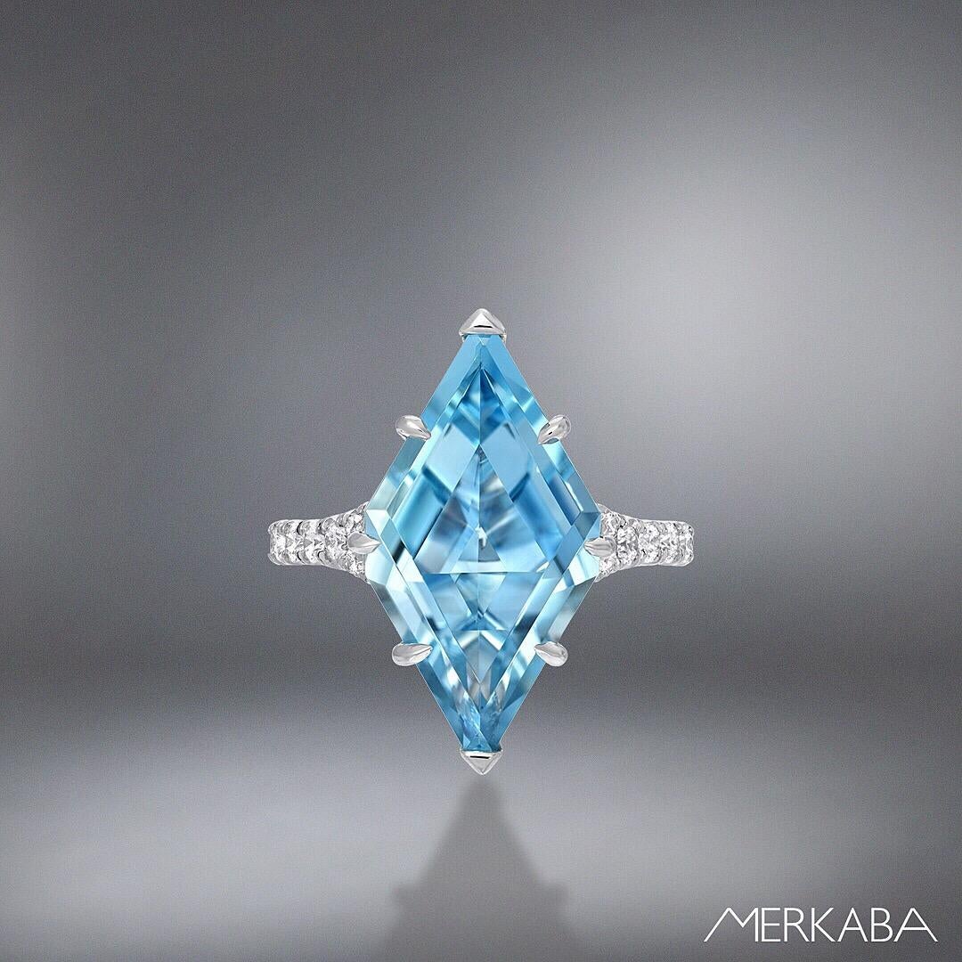 This 4.74 carat custom cut shield Aquamarine ring, is adorned by a total of 0.51 carat diamonds on the split platinum shank.
This unique Madagascar Aquamarine is hand set and secured by 6 knife edged, claw shaped prongs. 
Size 6. Resizing is