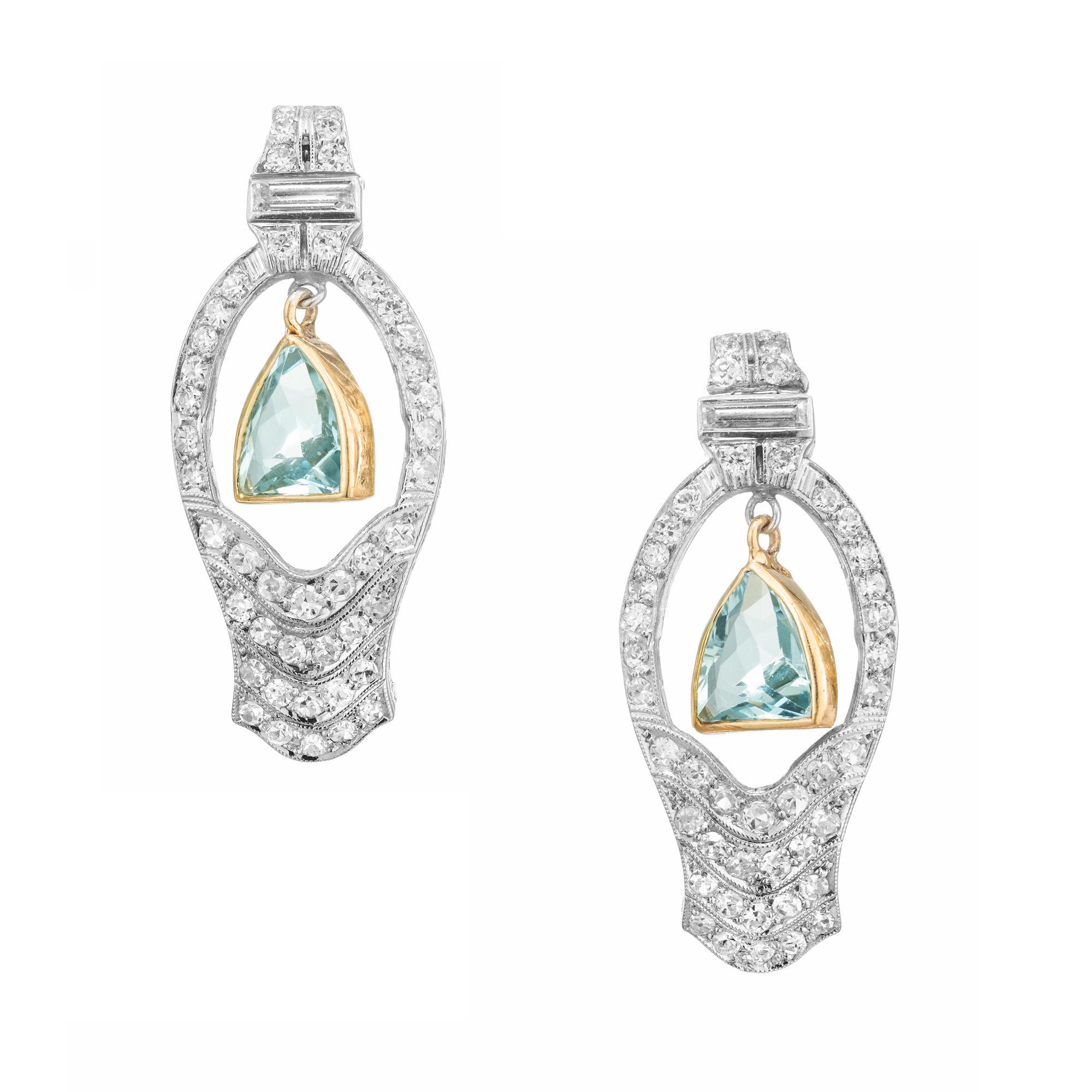1940s Art Deco Aquamarine and diamond dangle earrings. 2 shield cut 14k yellow gold bezel set aquas, dangle from a Platinum open setting that is adorned with 45 single cut  diamonds and accented with one baguette cut diamond. An perfect example of