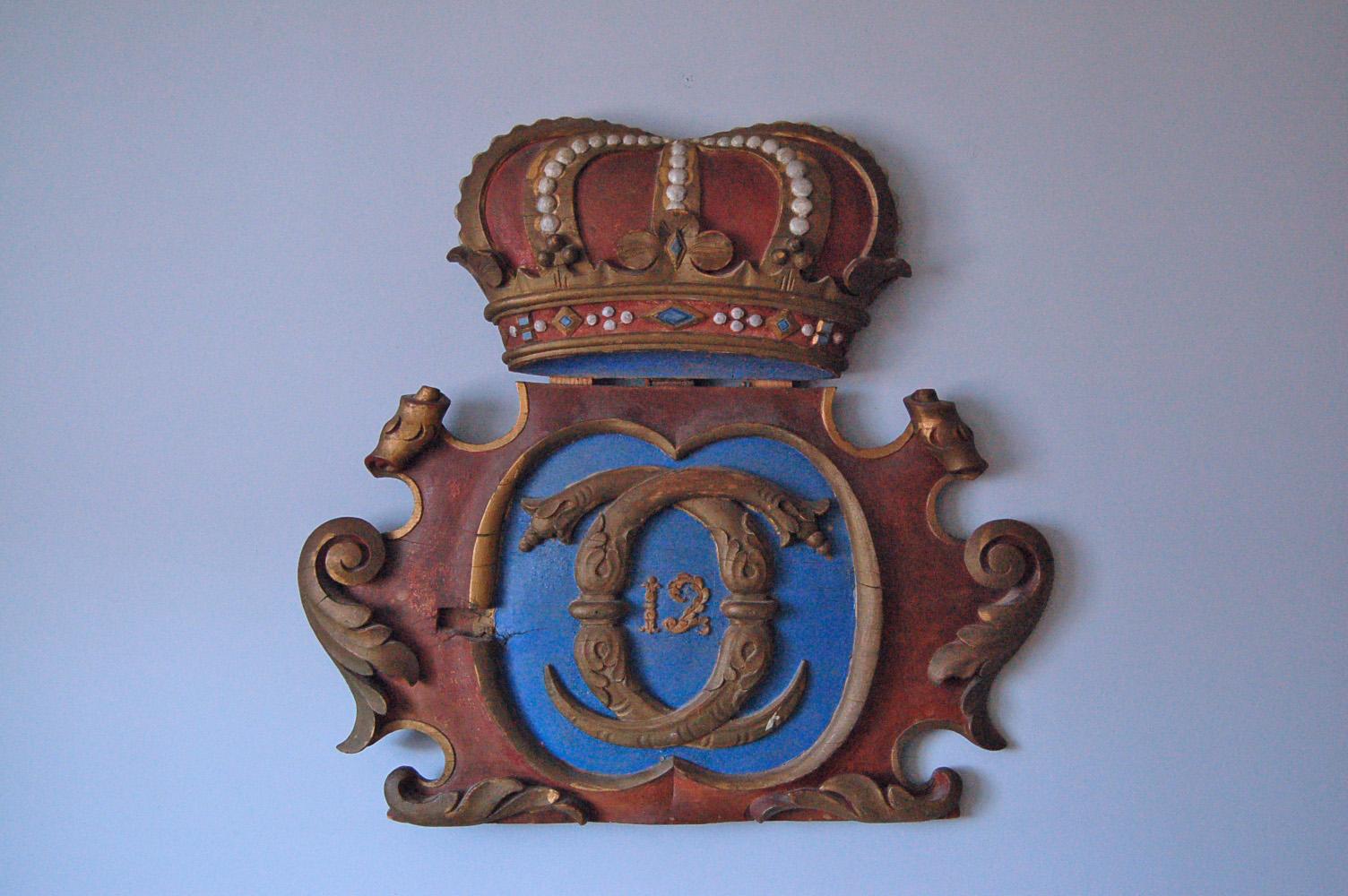 Shield of royal coat of arms of Carl XII topped with royal (Kunglig) crown, origin: Sweden, circa 1810 - 1820, hand-carved wood and hand-painted.