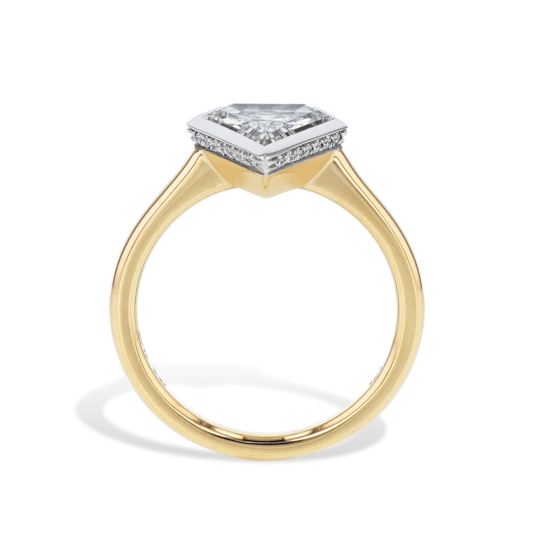 This stunning, handcrafted engagement ring features a magnificent shield-shaped diamond in the center, surrounded by 25 pave-set diamonds underneath. The platinum and 18kt yellow gold shank adds a touch of elegance and luxury, making it a truly