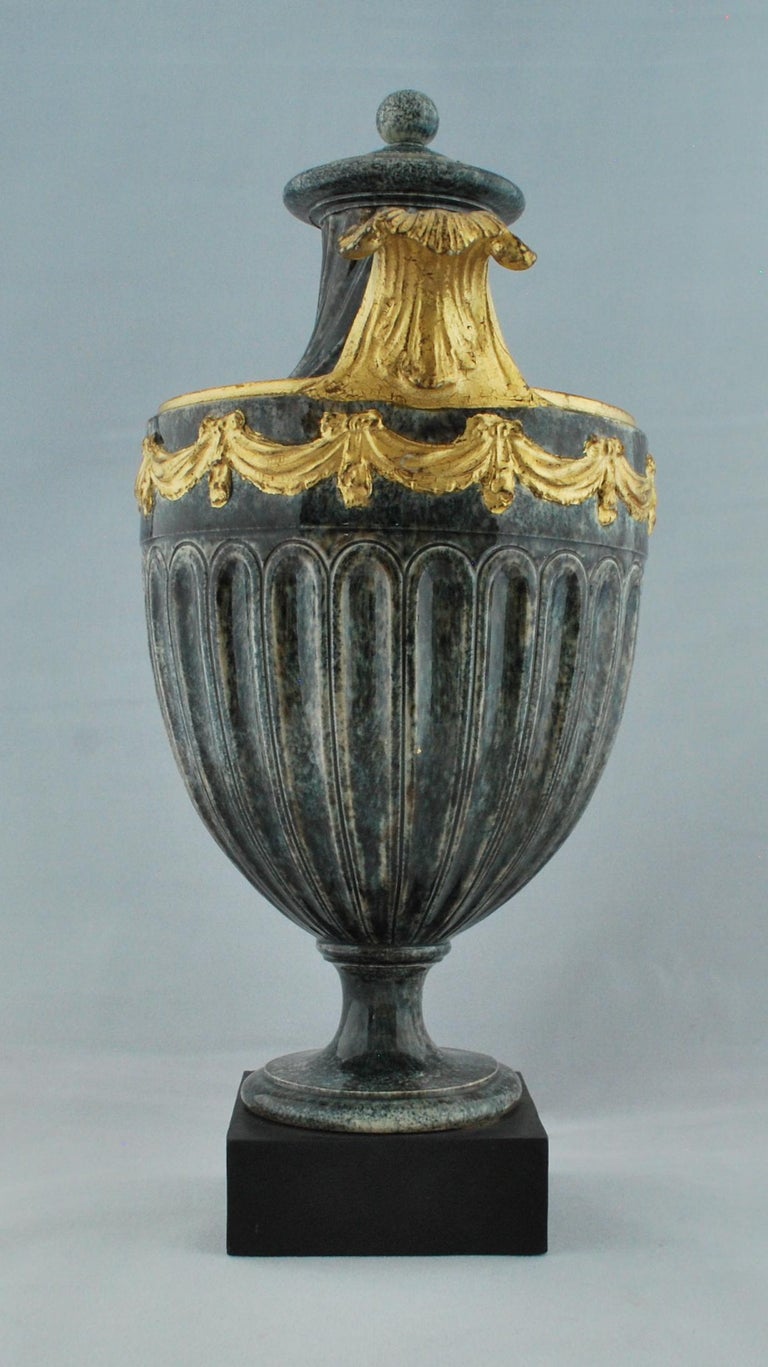 A shield-shaped vase, decorated to resemble porphyry, and highlighted with gilding.

Marked for Wedgwood & Bentley.