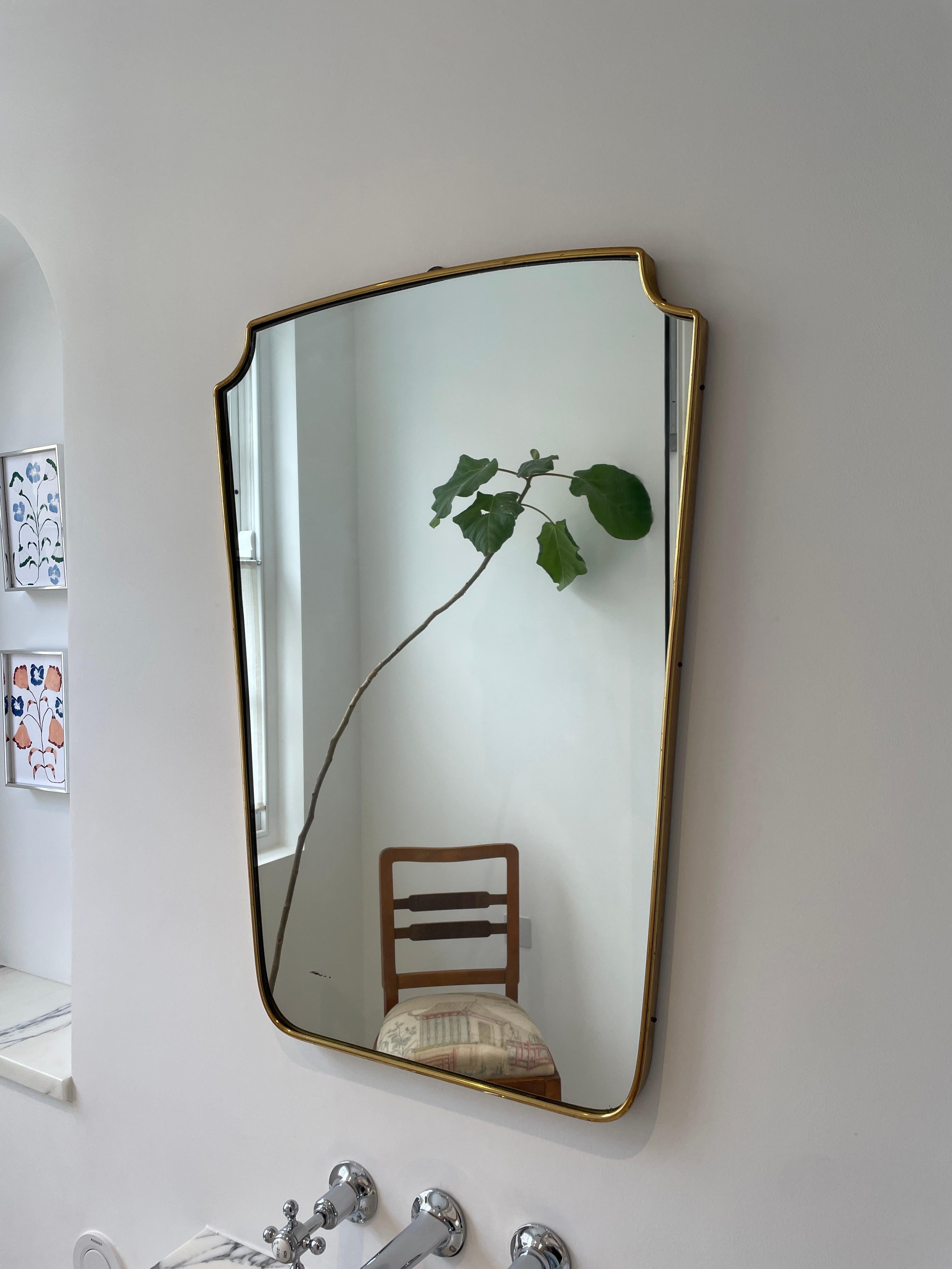 Designer: Unknown, Italian
Date: 1950s
Materials: Brass, wood, glass

Description: The 1950s Italian brass mirror is a vintage decorative item that reflects the distinctive style and craftsmanship of mid-century Italian design. It features a frame