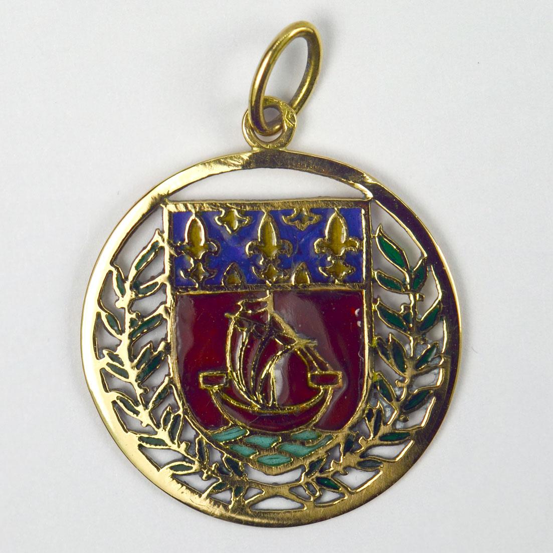 A French 18 karat (18K) yellow gold charm pendant designed as a shield of the coat of arms for the City of Paris, depicting a yacht or boat in full sail surrounded by a pierced laurel wreath, enhanced by plique-a-jour enamel work. Stamped with the
