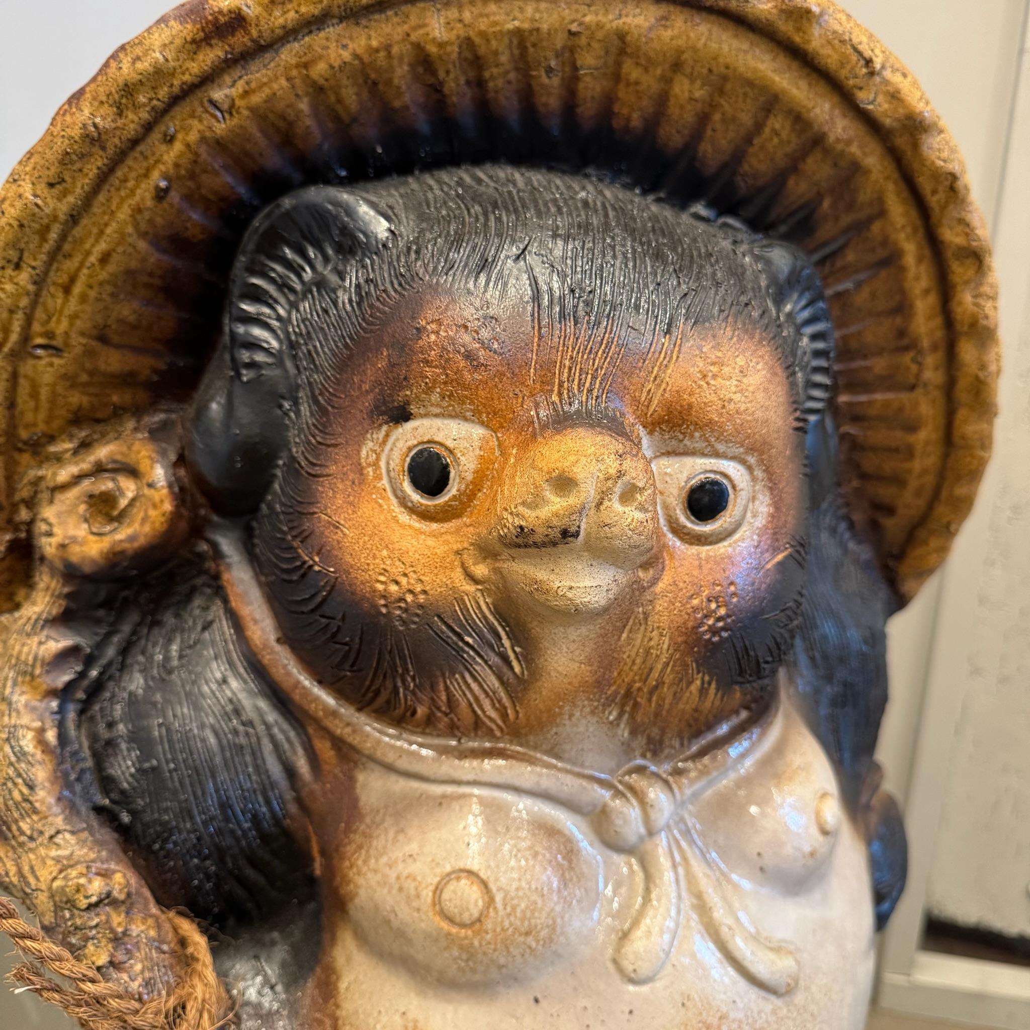 The Shigaraki Tanuki, a beloved icon of Japanese folklore, is a masterfully crafted lucky charm hailing from Shigaraki, one of Japan's most esteemed pottery regions. This whimsical representation of the tanuki, or raccoon dog, embodies the essence