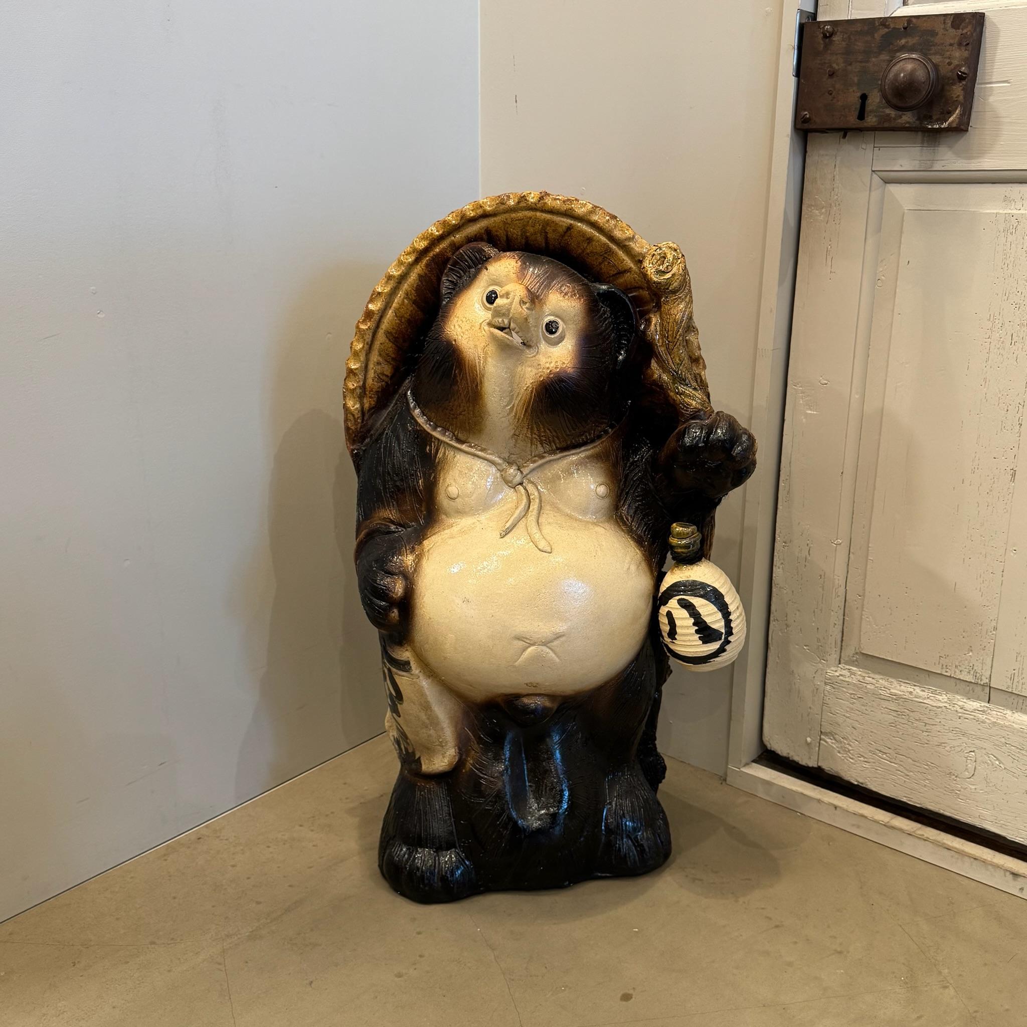 The Shigaraki Tanuki, a beloved icon of Japanese folklore, is a masterfully crafted lucky charm hailing from Shigaraki, one of Japan's most esteemed pottery regions. This whimsical representation of the tanuki, or raccoon dog, embodies the essence