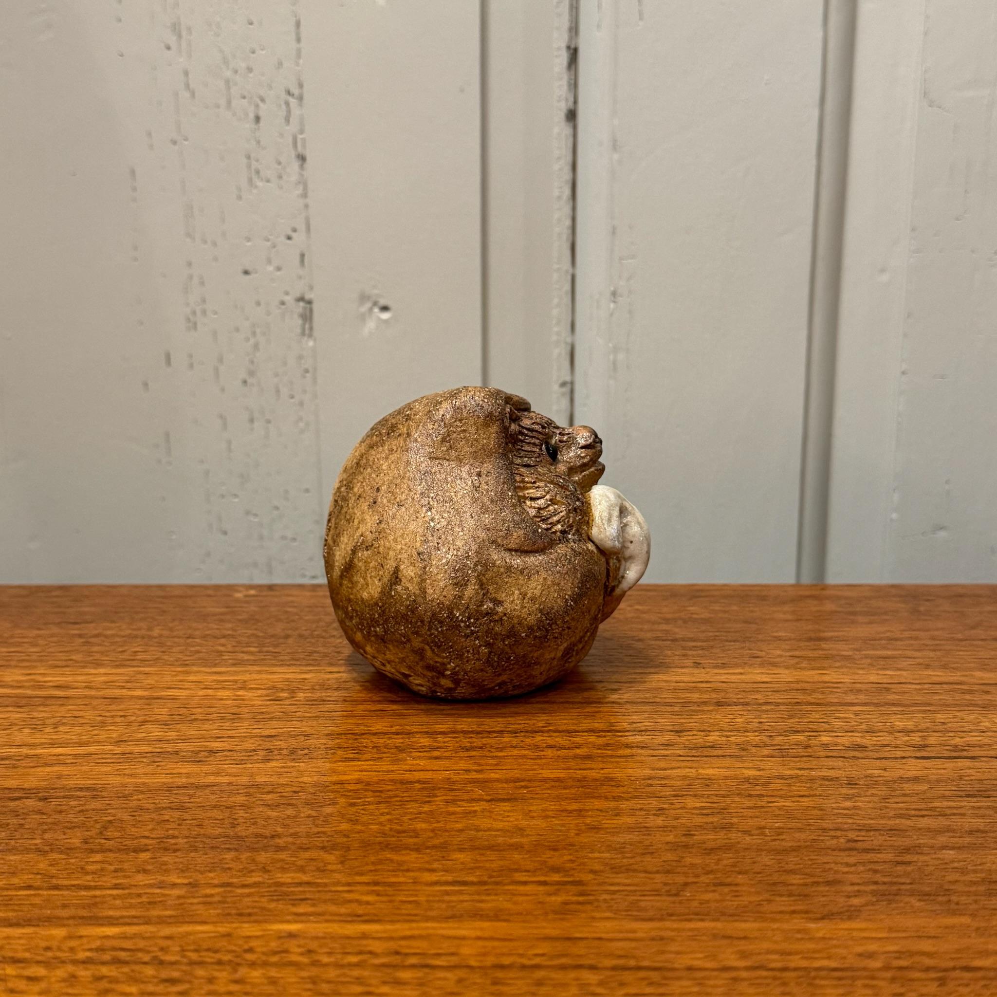The Shigaraki Tanuki, a beloved icon of Japanese folklore, is a masterfully crafted lucky charm hailing from Shigaraki, one of Japan's most esteemed pottery regions. This whimsical representation of the tanuki, or raccoon dog, embodies the essence