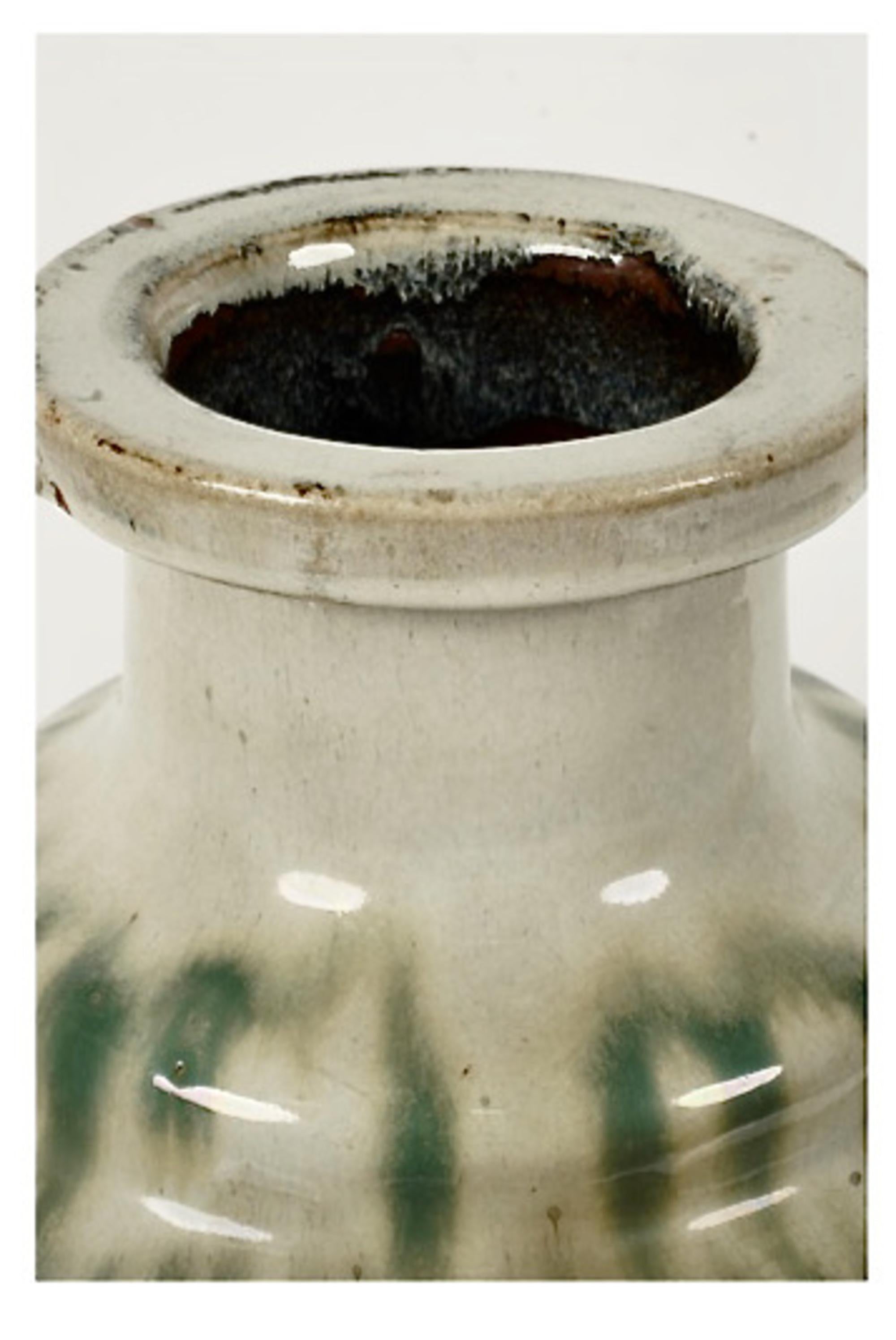 This is a very good example of a Shigaraki Tsubo vessel whose intended purpose was to contain water. Note the spout located at the bottom of the jar. This example of Shigaraki ware is drip glazed. The Tsubo date to the end of the Edo or beginning of