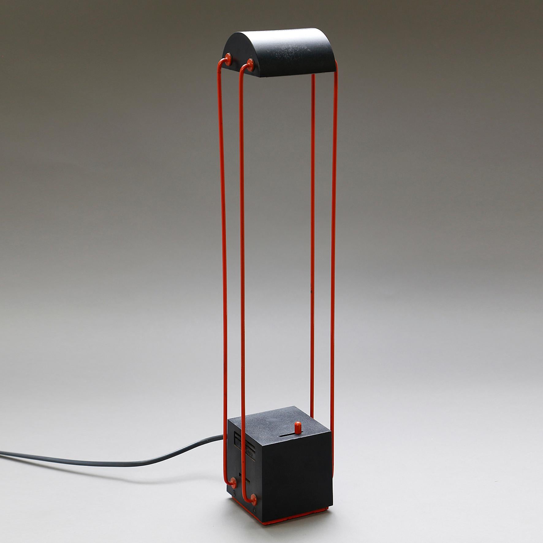 Tokio

A black and red ABS and metal table lamp. The half-cylinder shape reflector on four mobile arms on a cubic base with an integrated dimmer.
Original edition by Stilnovo.
Italy, 
circa 1980.

Note
One lamp in the collection of the