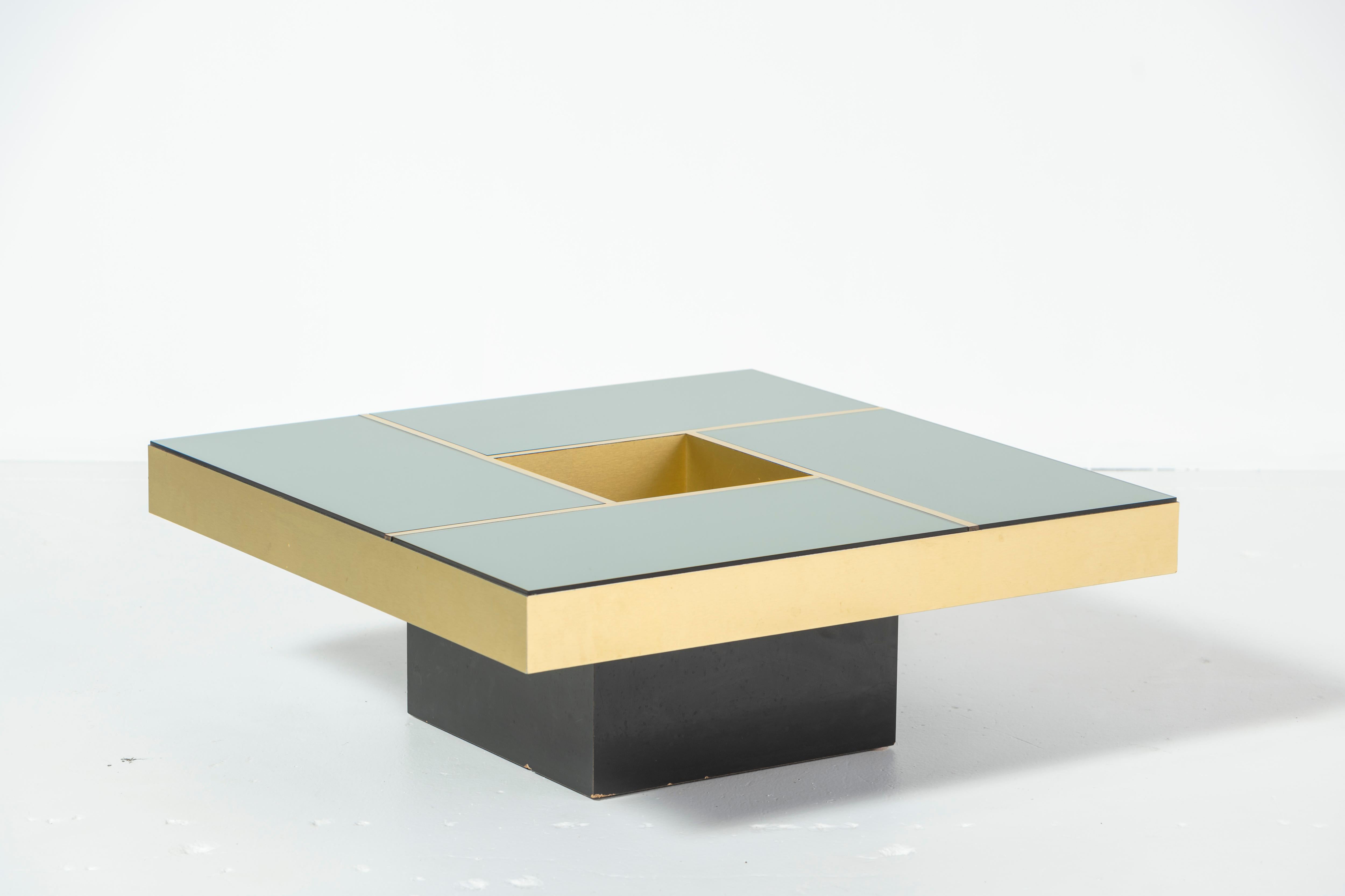 Coffee table 'Shilling' designed by Giovanni Ausenda, Guido Baldo Grossi & Gianni Gavioli for NY Form of Bologna in the 1970s. Amazing gold colored table with a smoked mirror top that is divided into four sections by gold bands. This table gets a