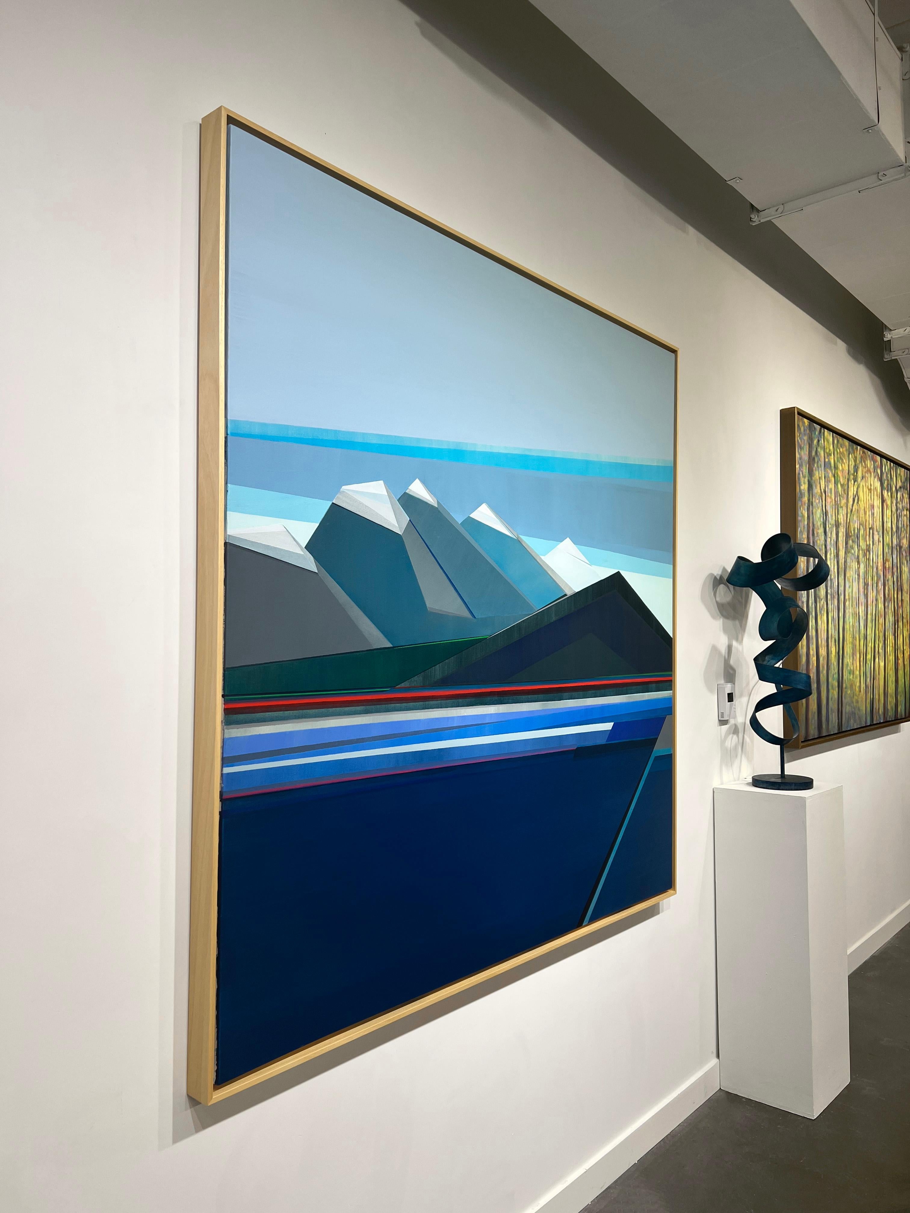 This abstract geometric landscape painting by Shilo Ratner features a cool blue palette. The artist uses her signature geometric shapes and lines to create a mountain range. Different shades of blue, teal, and grey are layered in triangles and