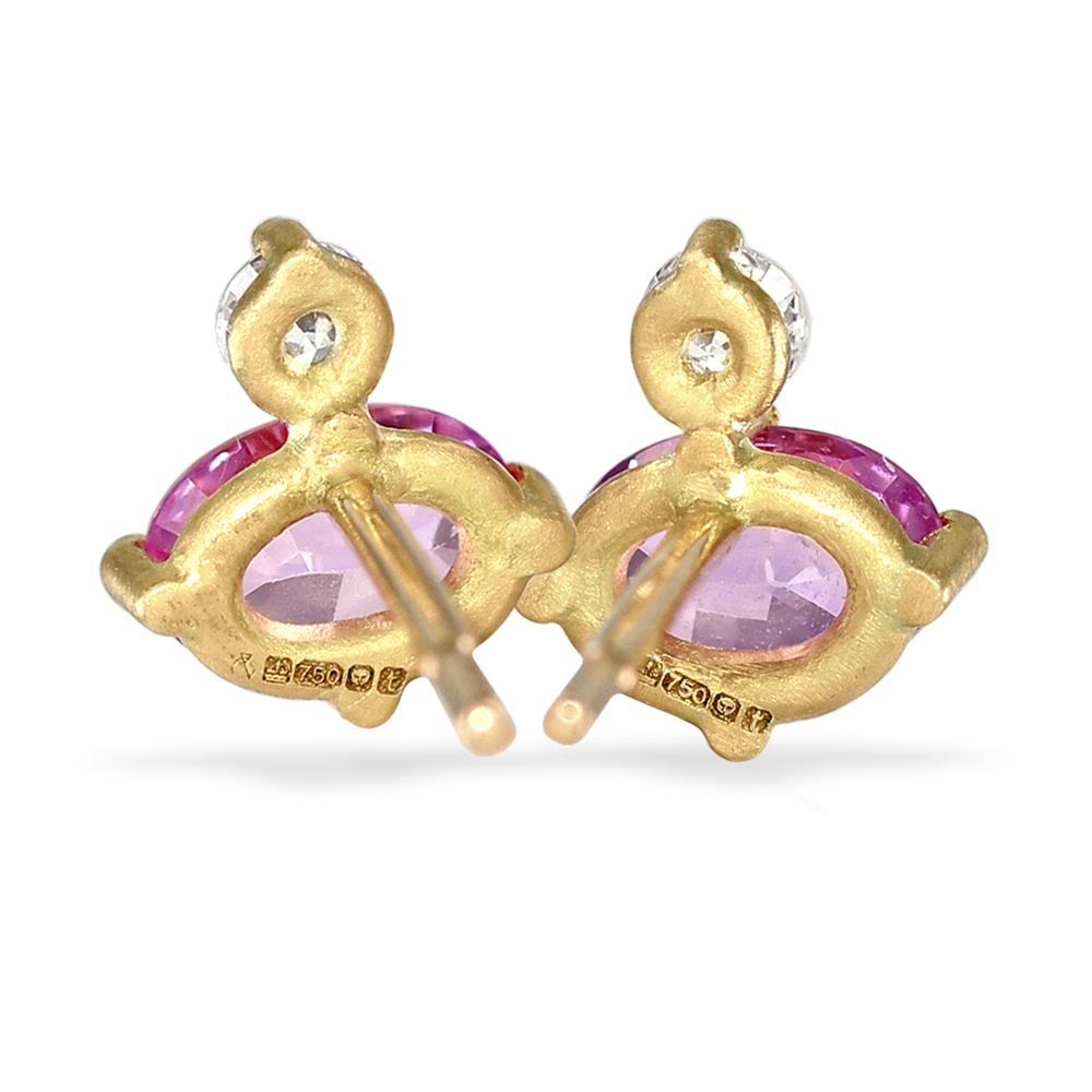Oval Duo Stud Earrings hand-fabricated in London by jewelry maker Shimell and Madden, featuring a gorgeous pair of shimmering faceted oval pink sapphires set beneath two round brilliant-cut white diamonds totaling 0.10 carats, all bezel-set in