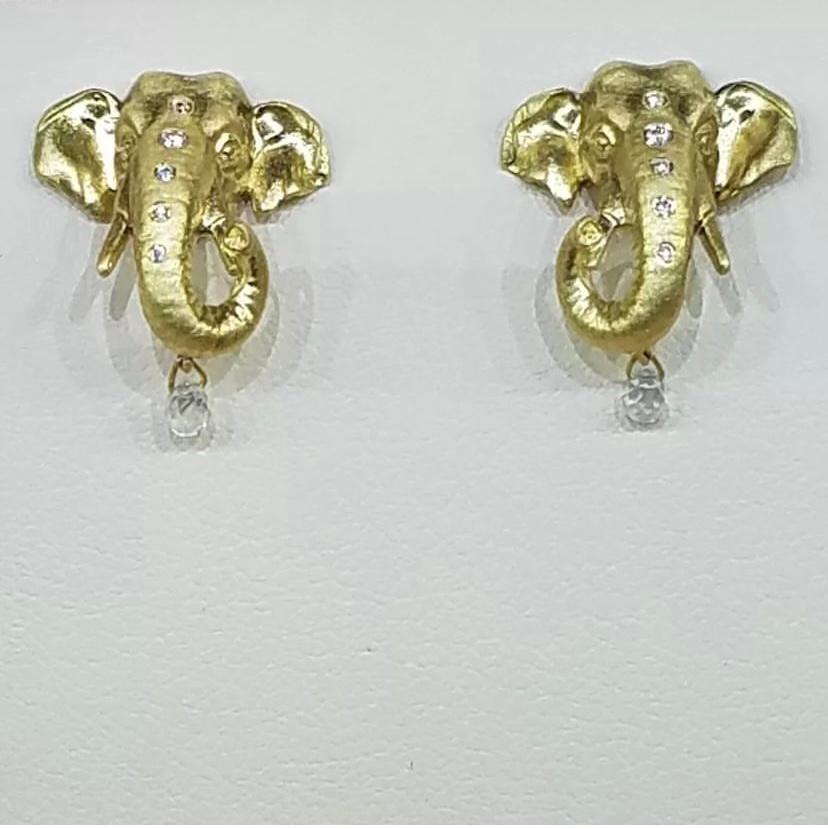 These gorgeous, highly detailed 18k rich yellow gold Elephant earrings glimmer as the light reflects off of the diamonds. 
Each elephant's trunk is adorned with a row of six diamonds which descends down the front of the trunk, leading to the