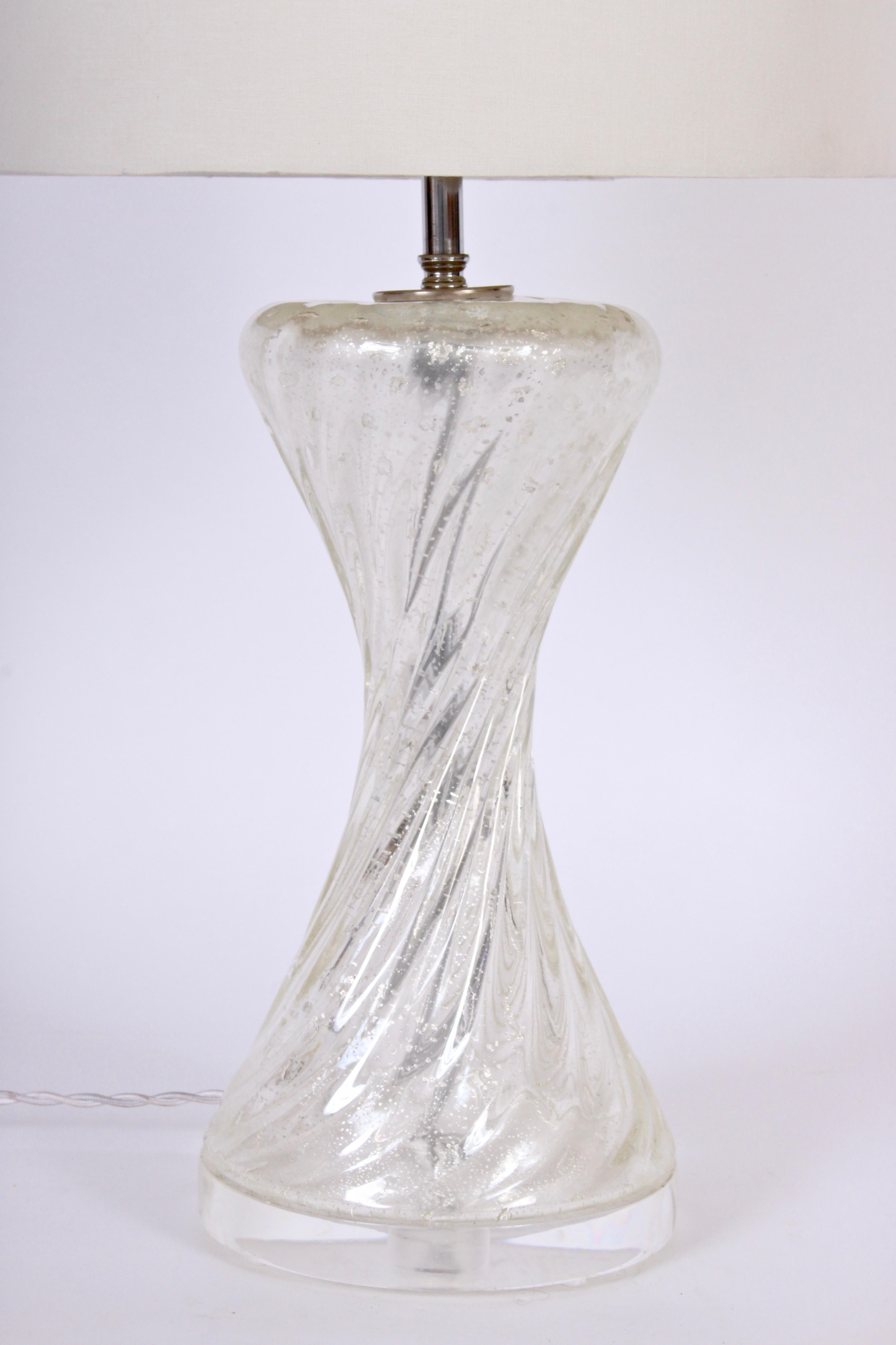 Italian Modern ribbed twist translucent Murano Glass Table Lamp with Silver inclusions. Featuring a smooth swirled hourglass form with bubbles and reflective silvered inclusions on a round Lucite base. Shade shown for display only and not for sale