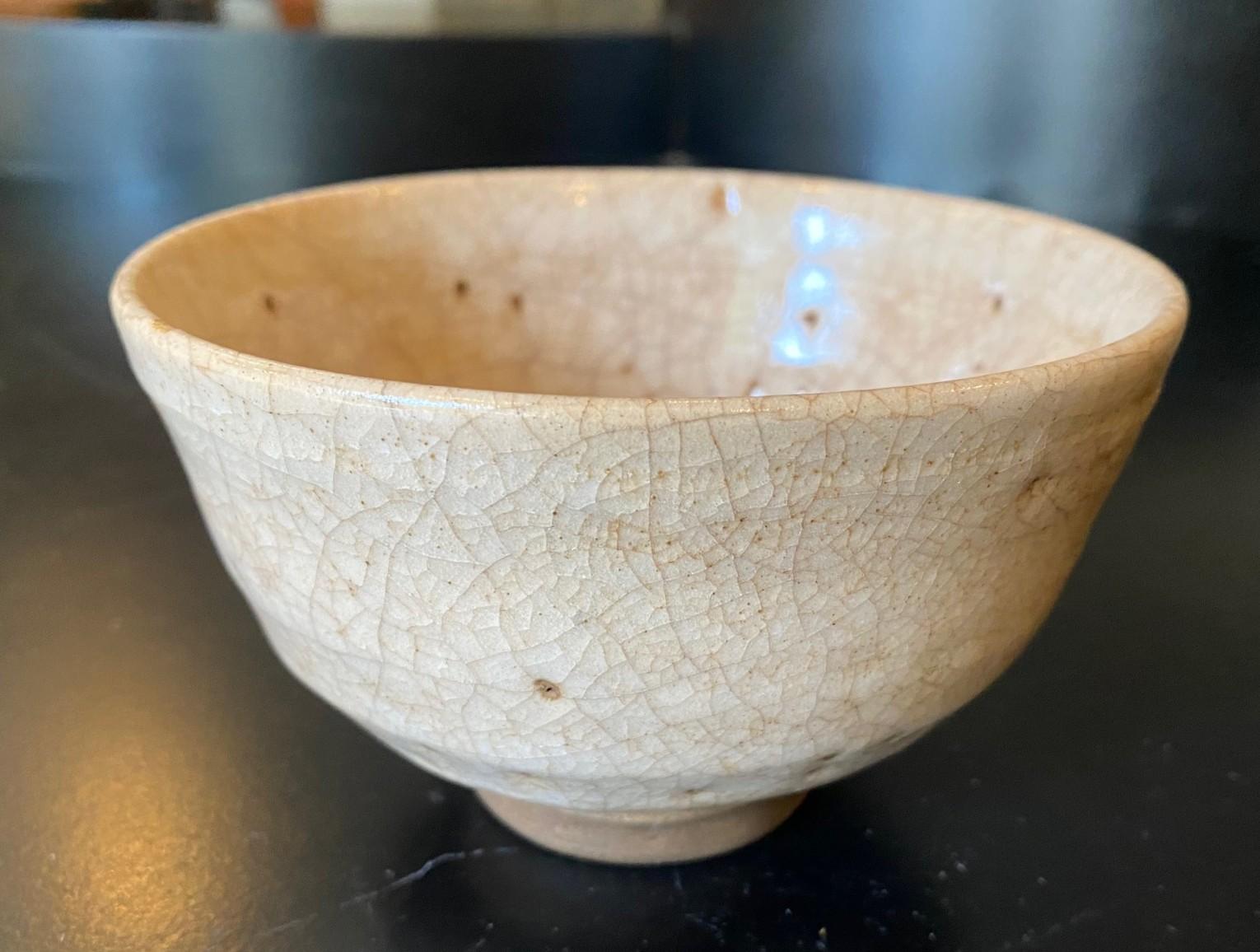 A wonderfully hand crafted and beautifully glazed Hagi Yaki Ware Chawan tea bowl by the 10th Shinbei Sakakura (X).  This piece has quite a special feel to it.  The Chawan  radiates in the light.  

For generations the Shinbei Sakaura family line