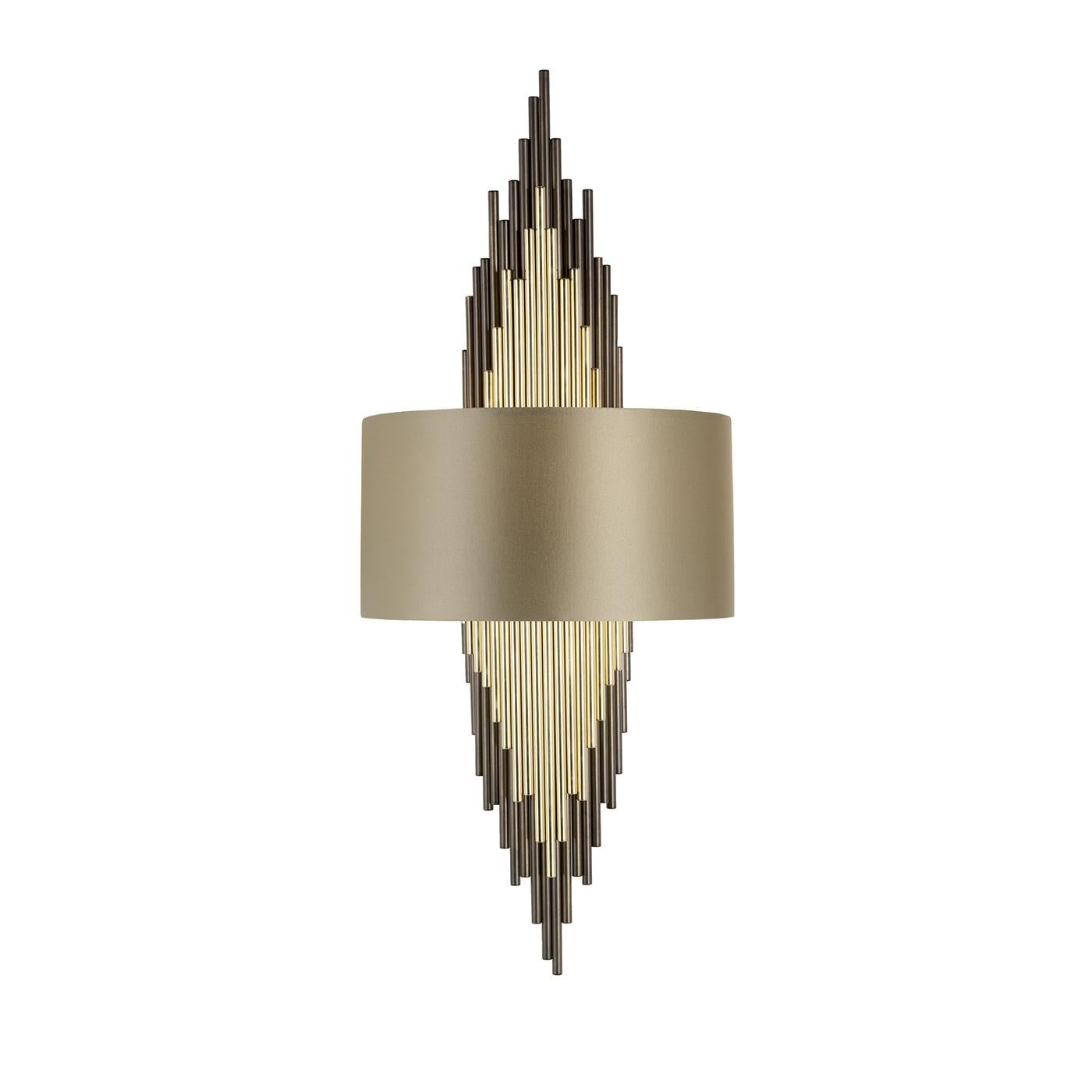 This magnificent sconce can be displayed alone or paired with another one to flank a mirror for a striking effect. Made entirely of brass, its vertical structure is made up of elements positioned at different heights to create the shape of a diamond