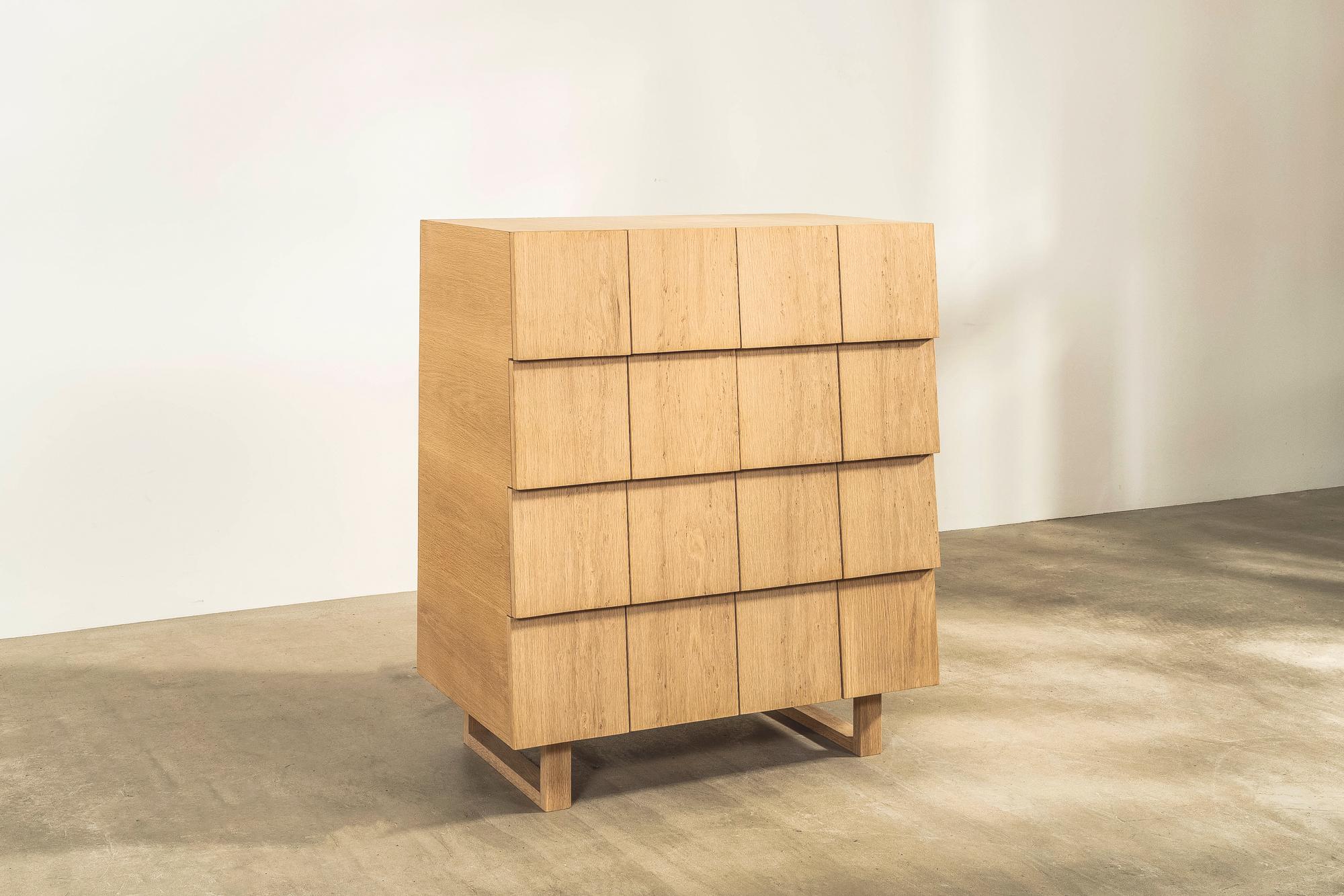 A stunning lacquered oak chest with solid wood drawers, designed by Industrial and furniture designers Shin and Tomoko Azumi. 

The fronts are consistent but hide a variety of different sized drawers. Starting with the top row, the number of