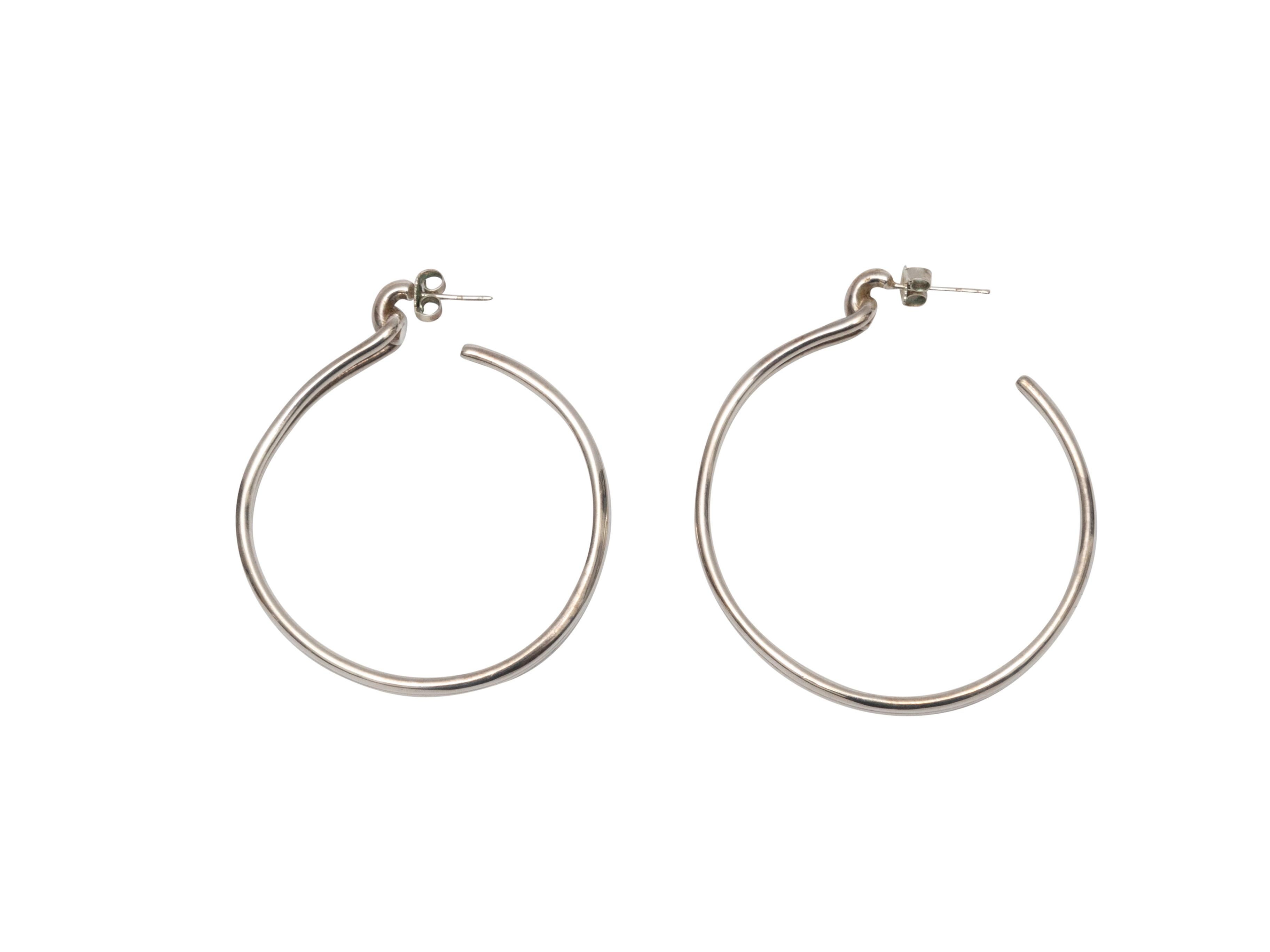Product Details: Silver pierced hoop earrings by Shinola. 1.5