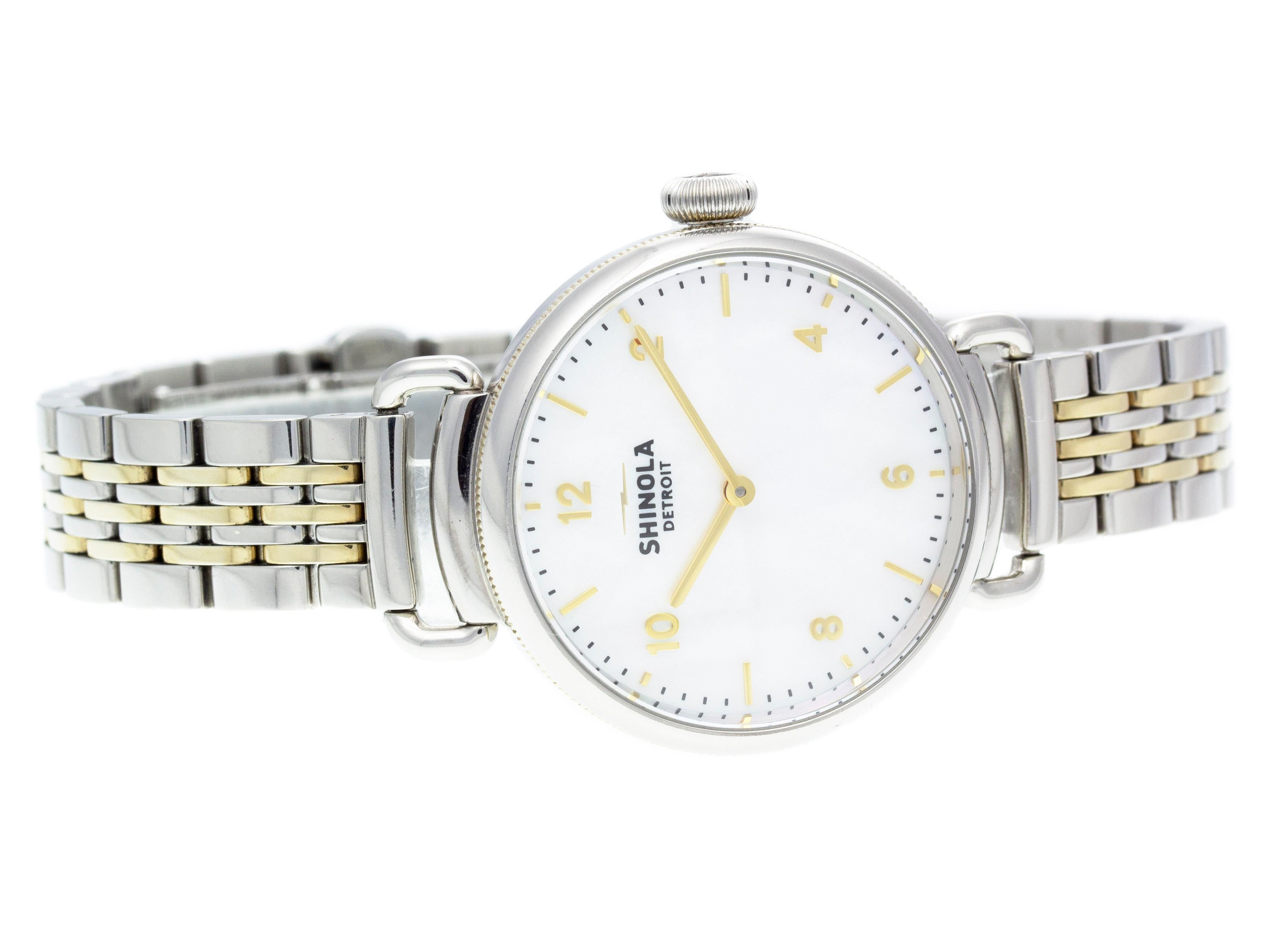 Steel Shinola The Canfield watch with a 32mm case, mother of pearl dial, and two tone bracelet with folding clasp. Features include hours and minutes. Comes with a Deluxe Gift Box and 2 Year Store Warranty.​

Brand	Shinola
Series	The