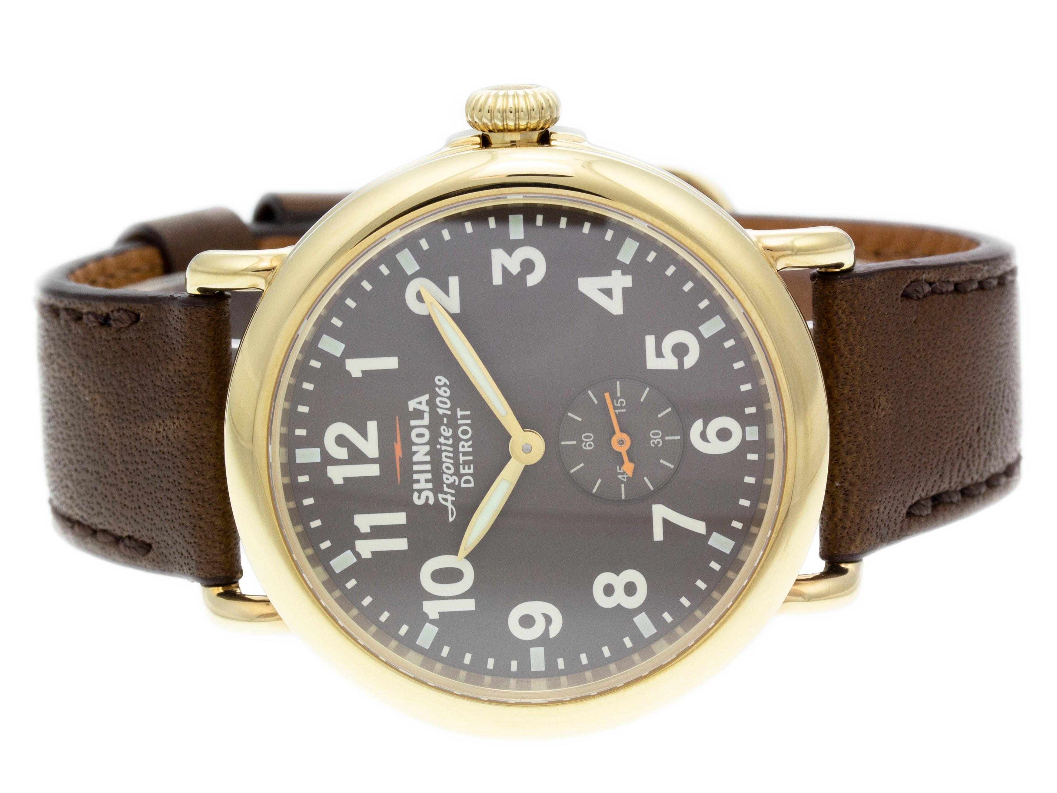 Gold PVD steel Shinola The Runwell quartz watch with a 41mm case, heather brown / gray dial, and brown leather strap with tang buckle. Features include hours, minutes, seconds. Comes with a Generic Gift Box and 2 Year Store