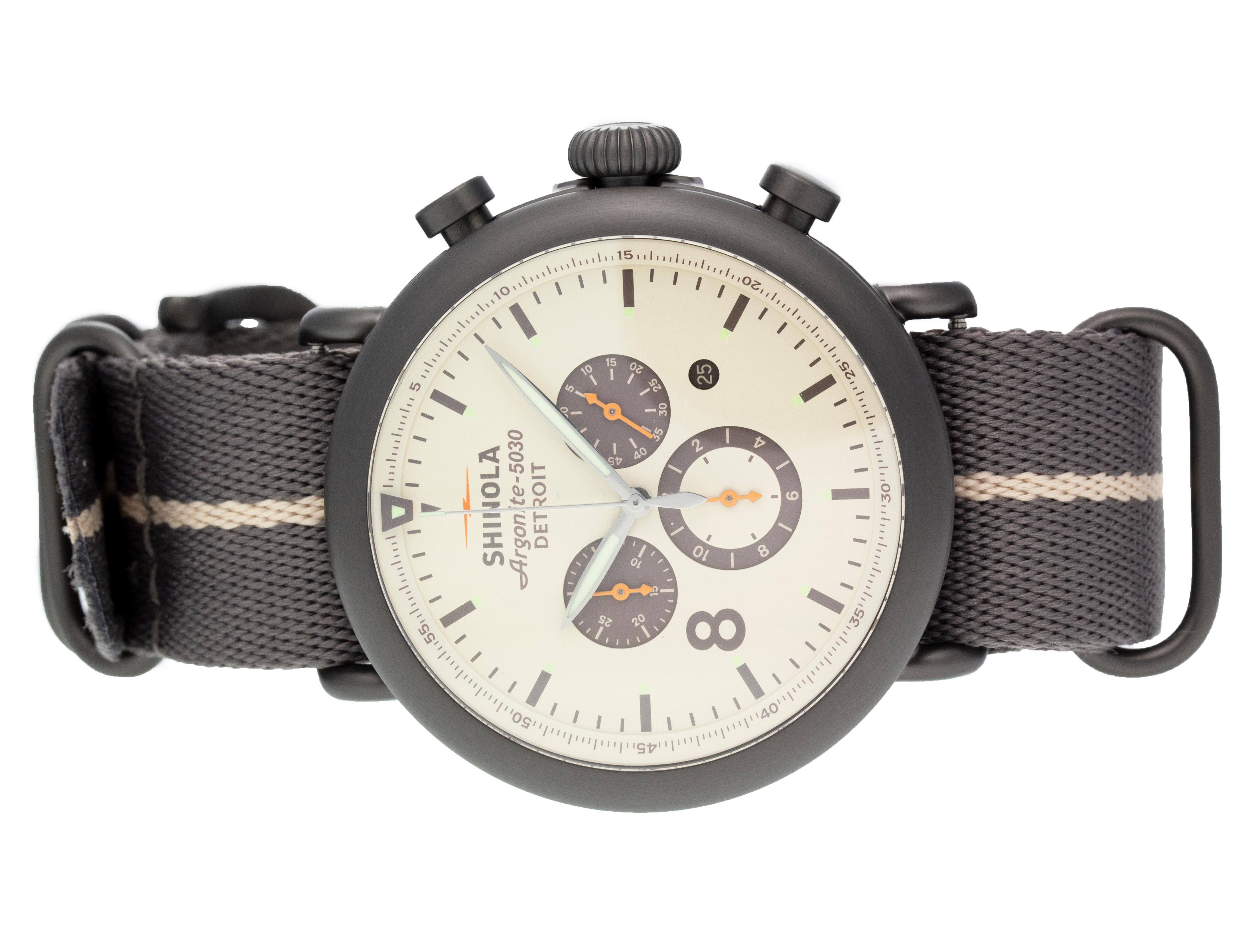 Steel Shinola The Runwell Contrast Chrono quartz watch with a 47mm case, cream dial, and nylon strap with tang buckle. Features include hours, minutes, seconds, date, and chronograph. It comes with a Deluxe Gift Box and 2 Year Store