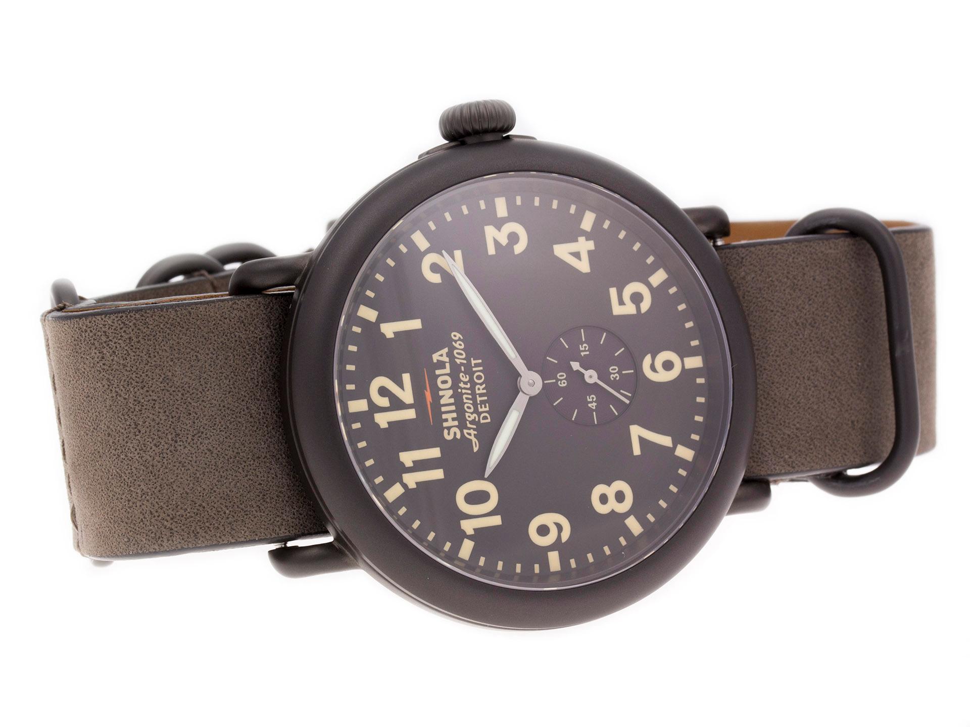 Gunmetal PVD Steel Shinola The Runwell Quartz Watch with a 47mm Case, Brown/Gray Dial, and Leather Strap with Tang Buckle. Features include Hours, Minutes, and Seconds. Comes with a Deluxe Gift Box and 2 Year Store