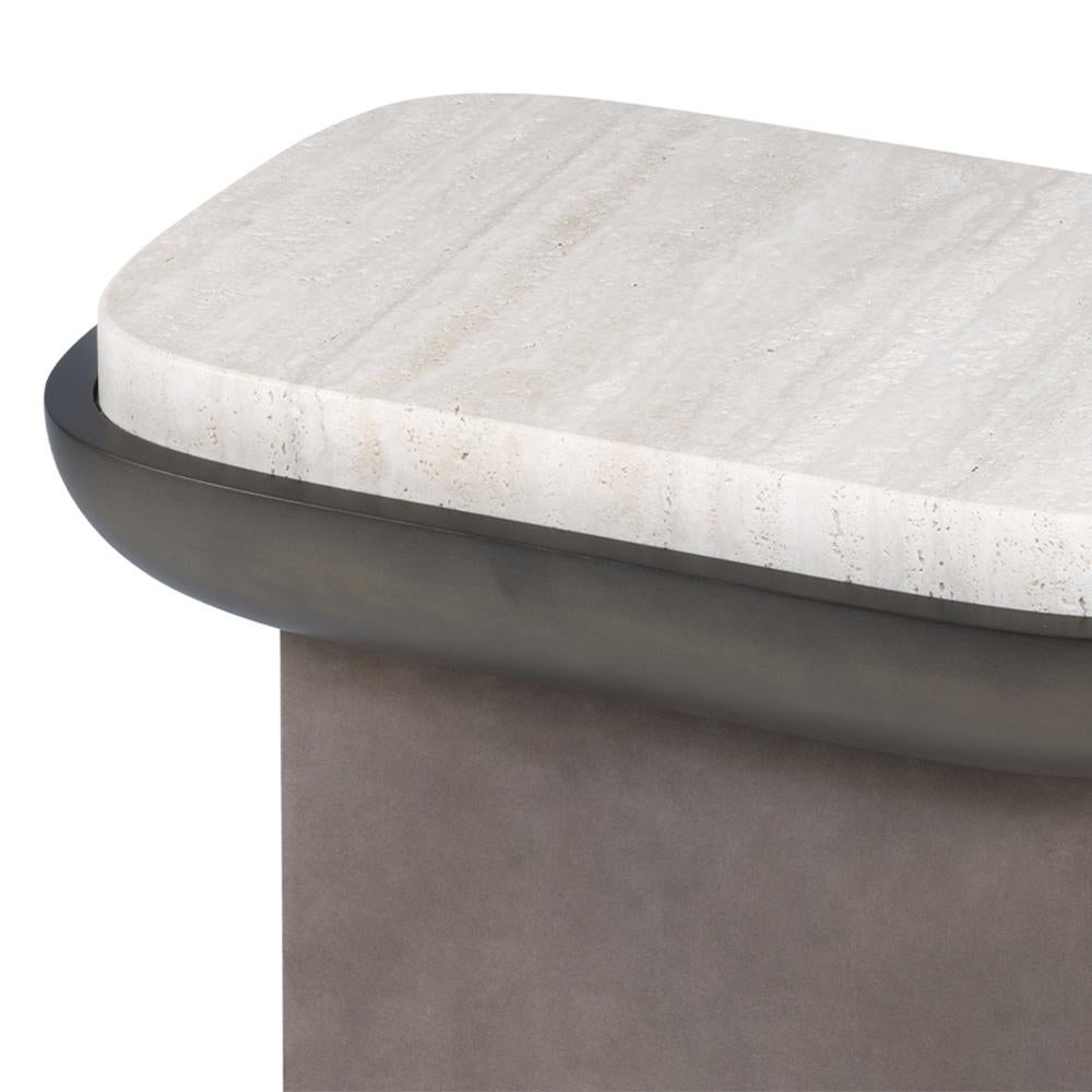 Side table Shinto Travertine with solid wood 
structure, base covered with suede leather in 
grey color. Top frame in solid wood in matte 
bronzage lacquered and with travertine top.