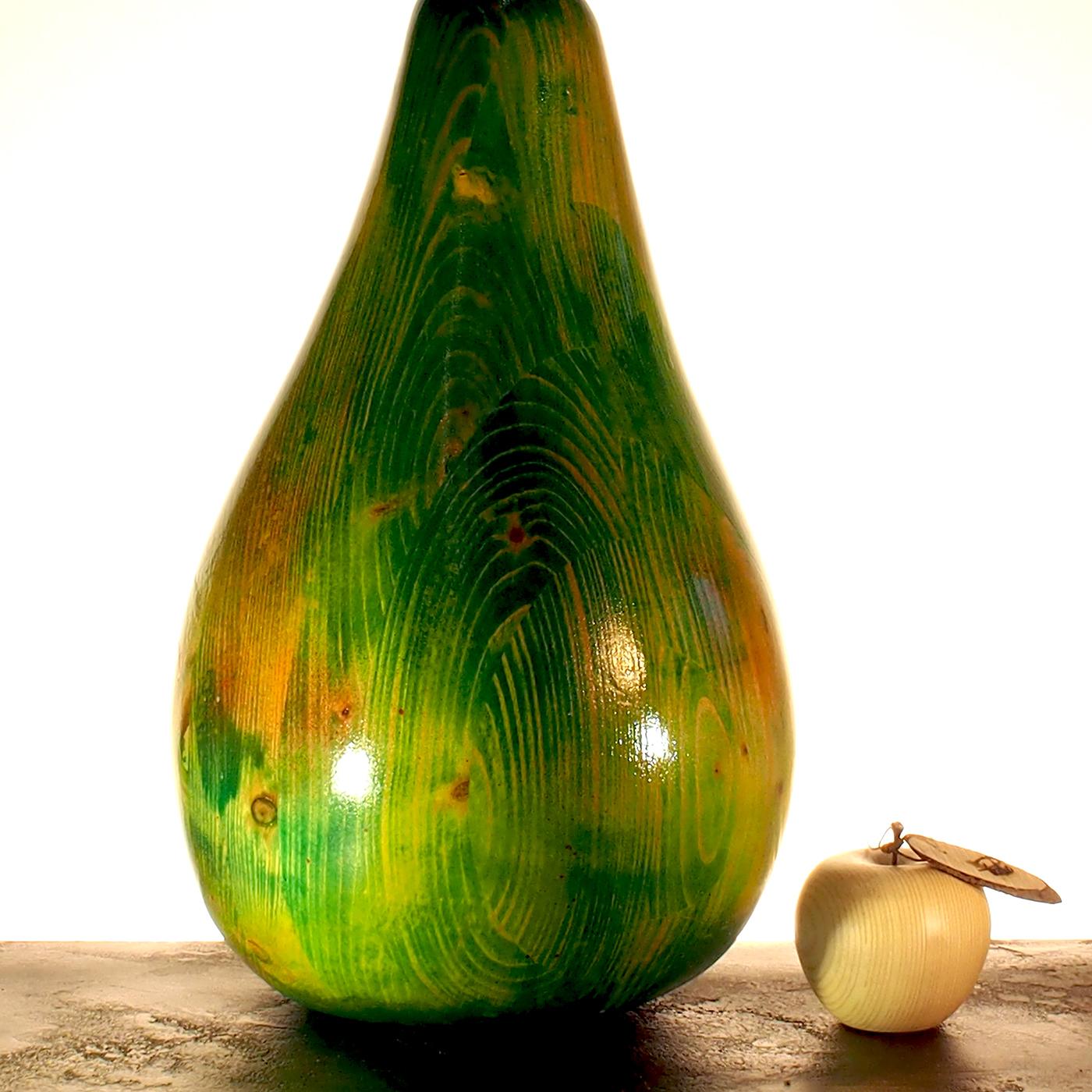 You’ll feel like sinking your teeth into this shiny green pear sculpture, a unique handmade piece by artisan Pietro Arnoldi. This sculpture was made from solid fir wood and its stem is an antique nail. Shaped with a chainsaw and polished by hand,
