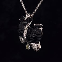 Shiny jet butterfly pendant, set with white gold and natural diamonds