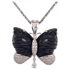 Shiny jet butterfly pendant, set with white gold and natural diamonds