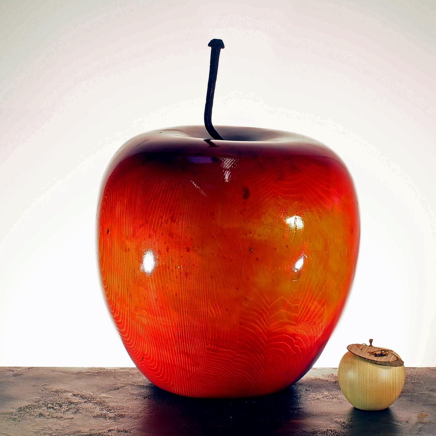 When looking at this shiny red apple sculpture, the mind instantly wanders to the story of Sleeping Beauty. This beautiful piece, hand-crafted by artisan Pietro Arnoldi, was carved with a chainsaw from solid fir wood and painted with multiple layers