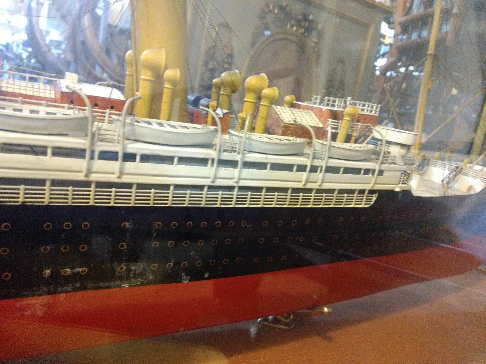 Ship model of German luxury liner with red and black painted hull in glass case with oak base and brass trim (KROMPRINSCESSIN CECILIE) att. Fleischmann Toy Co., Nuremburg
