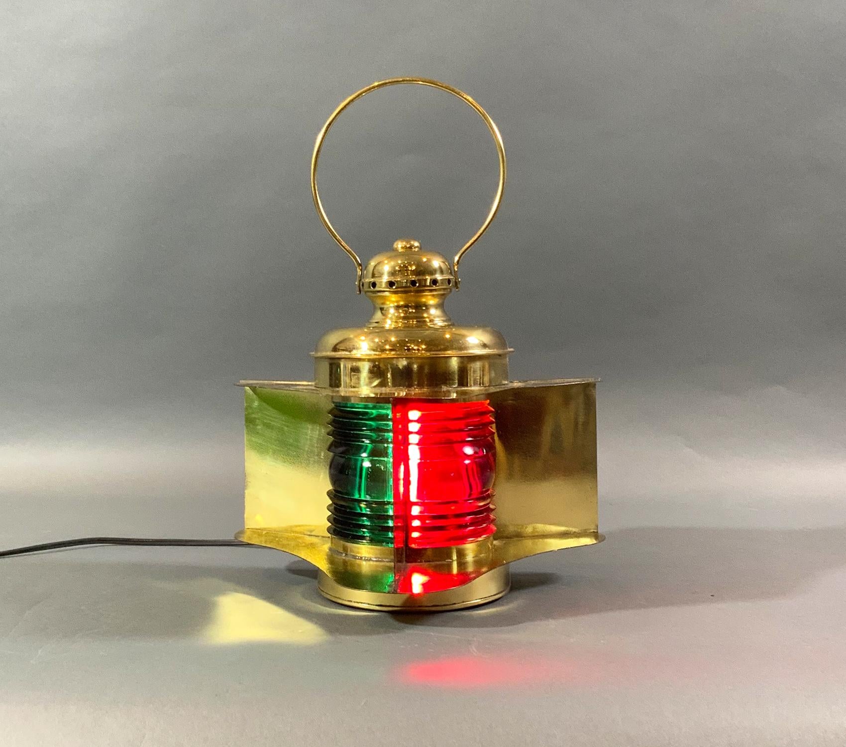 Ship’s port and starboard bow lantern with wide shroud and vane. Rich red and green Fresnel lenses. Manufacturer’s name is embossed on the hinged rear door, “MFRD” by Perkins Marine Lamp Corporation, Brooklyn, New York. This has been freshly