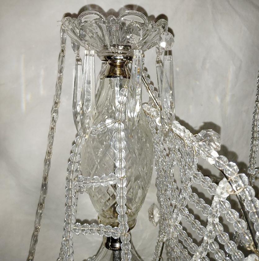 A circa 1930's French crystal chandelier in the shape of a ship with crystal sails, flags, and eight interior lights.

Measurements:
Height: 41