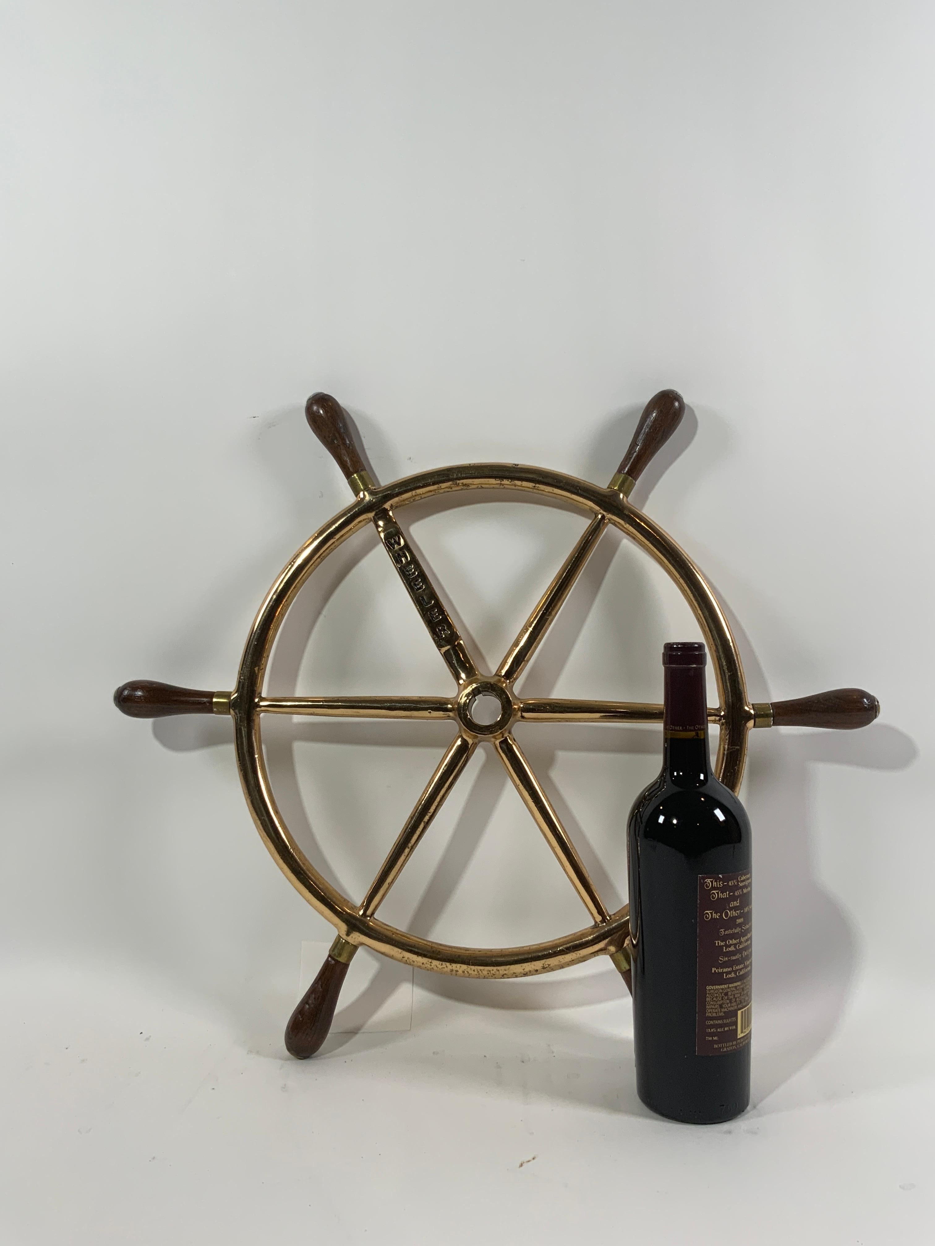 Solid brass ships wheel with the name wheeler cast into one of the spokes. Wheeler was a famous maker of yachts, up to seventy five feet, cabin cruisers, etc.

Hemingway wrote his famous novel 