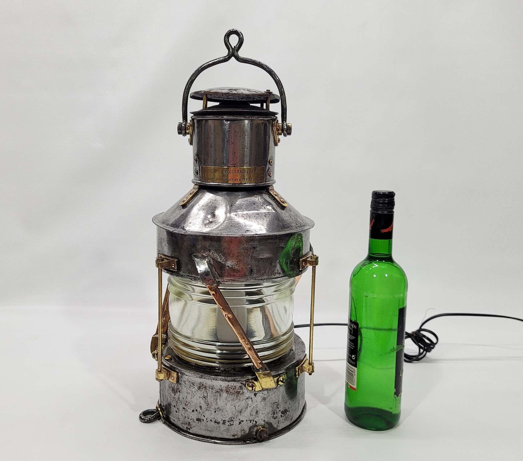 Anchor lantern from a boat of steel, copper and brass construction. Great piece of industrial lighting. Clear glass Fresnel lens. Copper bars. Brass trim. Vented top. Rewired with new socket. This lantern has been stripped, polished, and lacquered