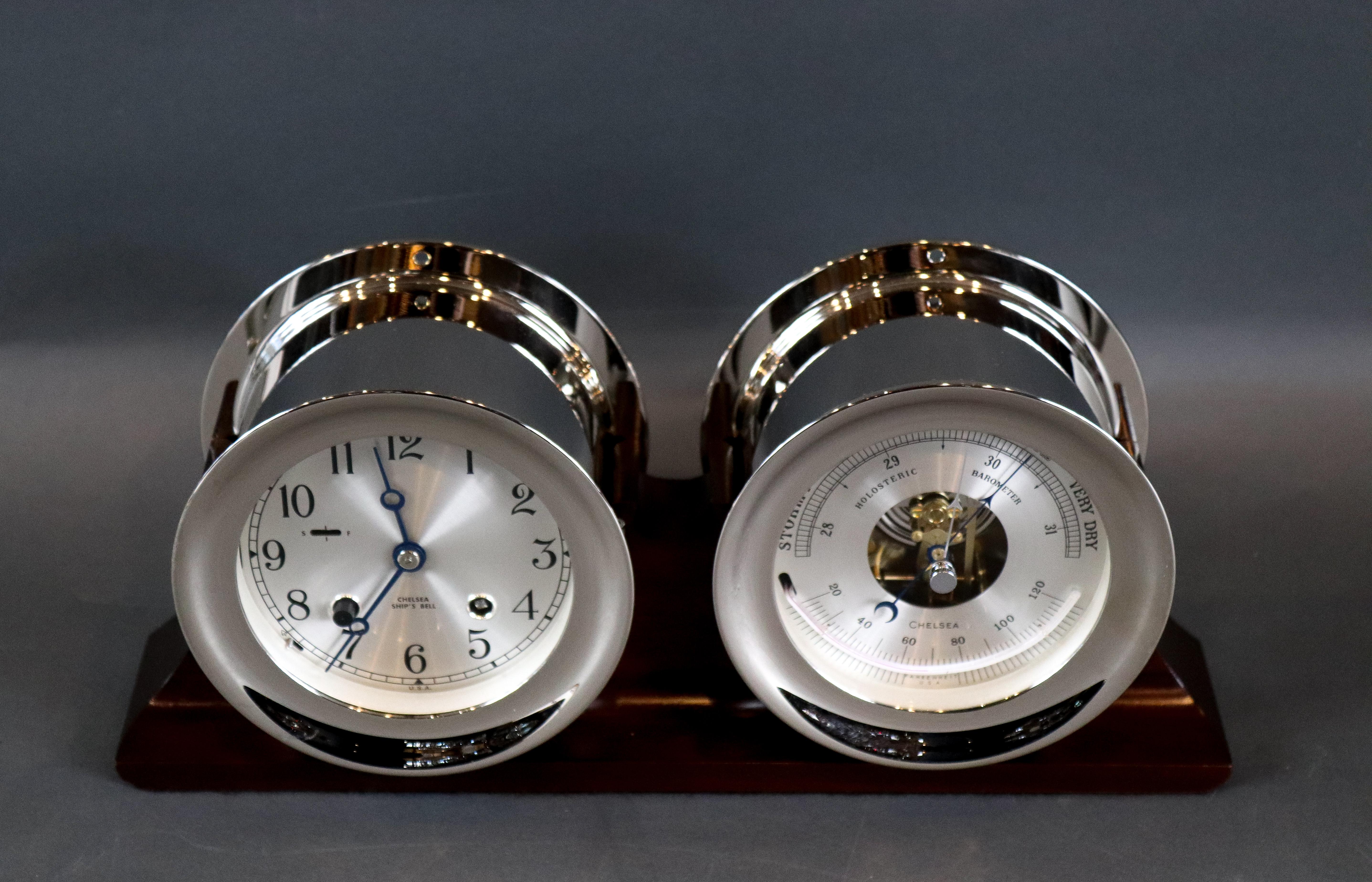 Chelsea ship's bell clock and barometer set mounted to a wood base. Nickel-plated over solid brass cases. Four inch faces. 14 1/2 x 4 x 7