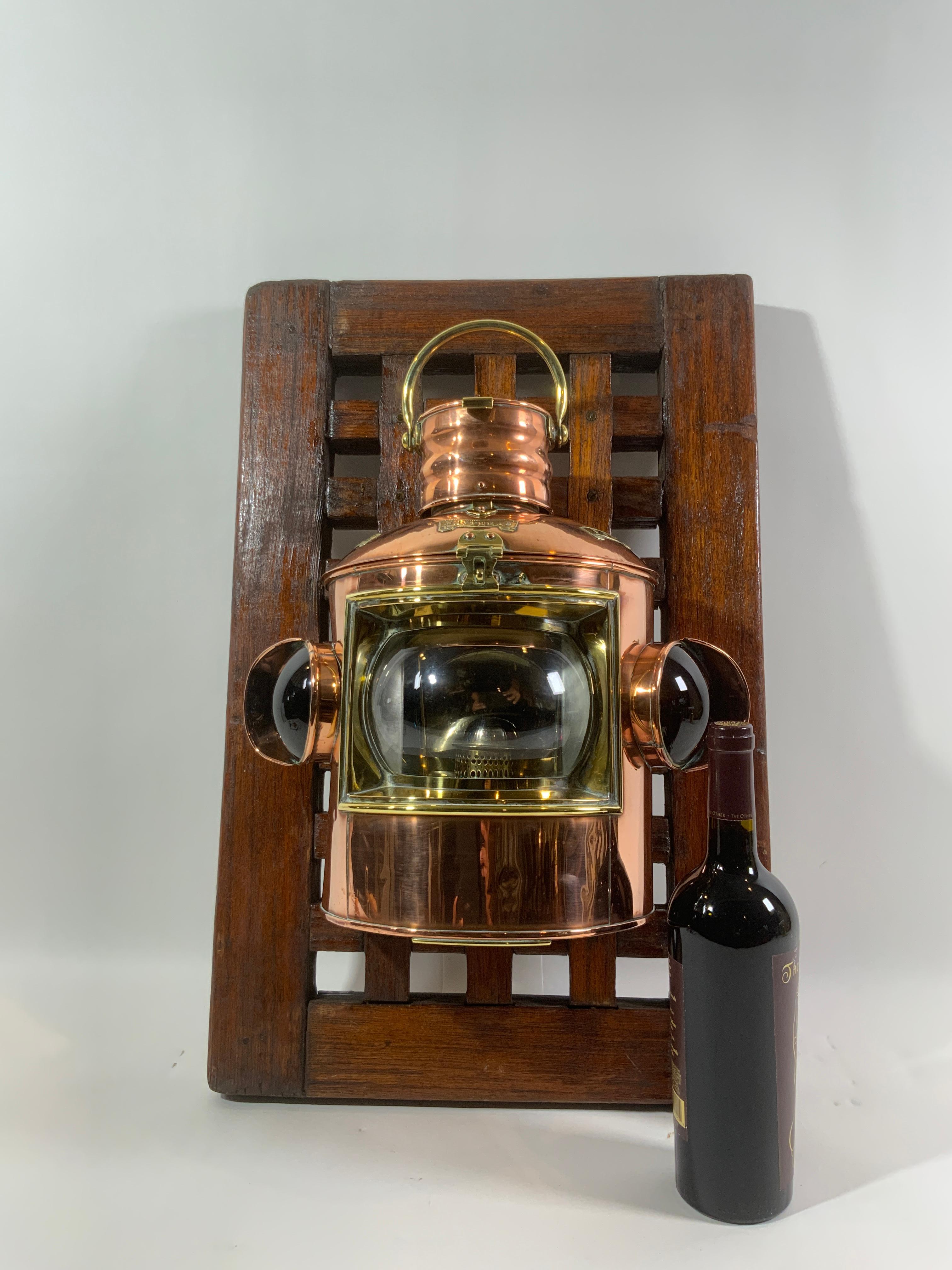 This great nautical lantern is as good as they come. Brass trim includes hasp, handle, bezel, etc.

The lantern is mounted on a section of ships grating creating an awesome display.

Weight:
Overall Dimensions: 15