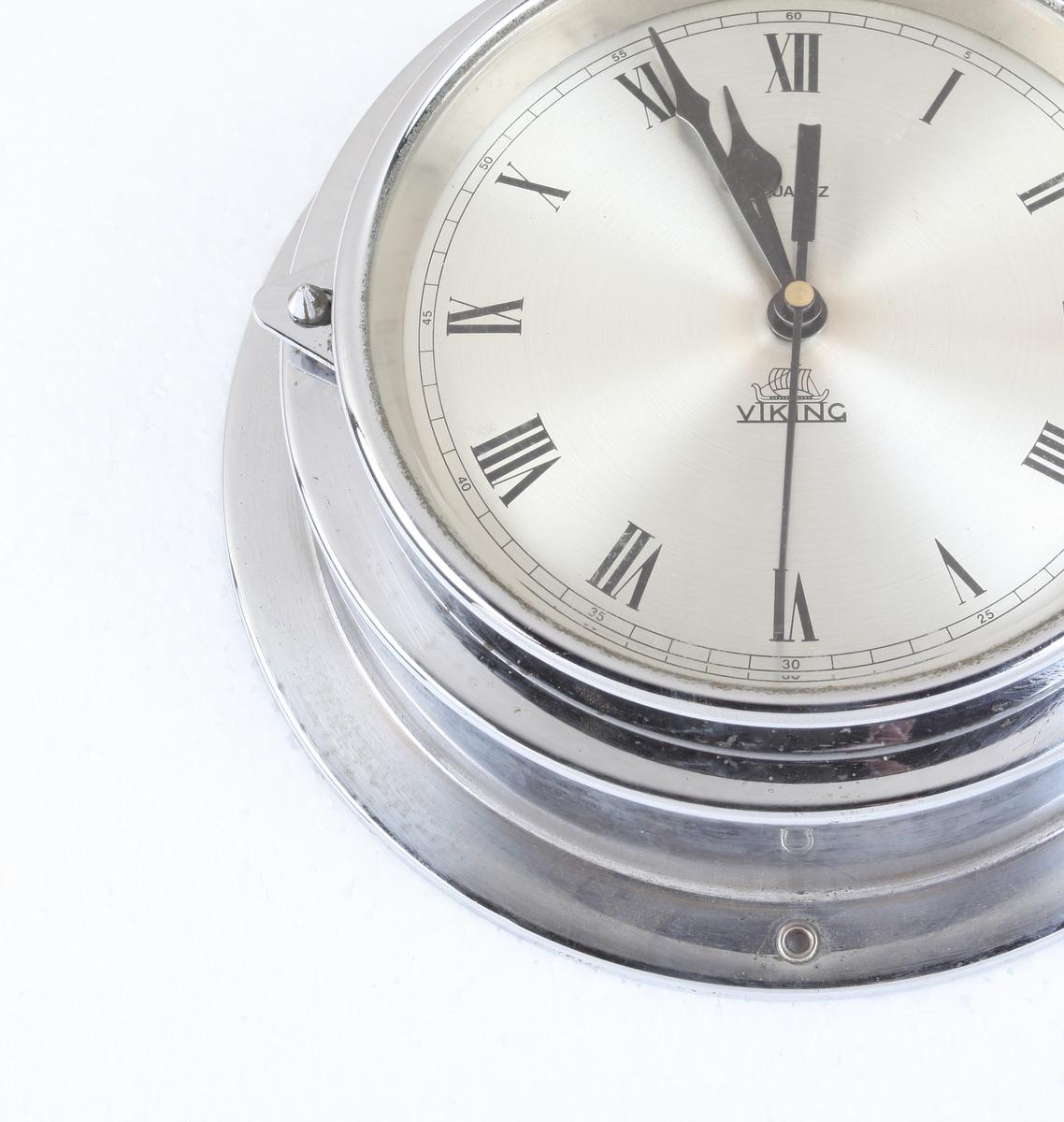 A ship's chrome, battery operated wall clock by Viking. Signed Weilbach & Co., Copenhagen. Battery mechanism replaced putting it in good working order; and piece has been polished up. Roman numeral nickel face which measures 6.25