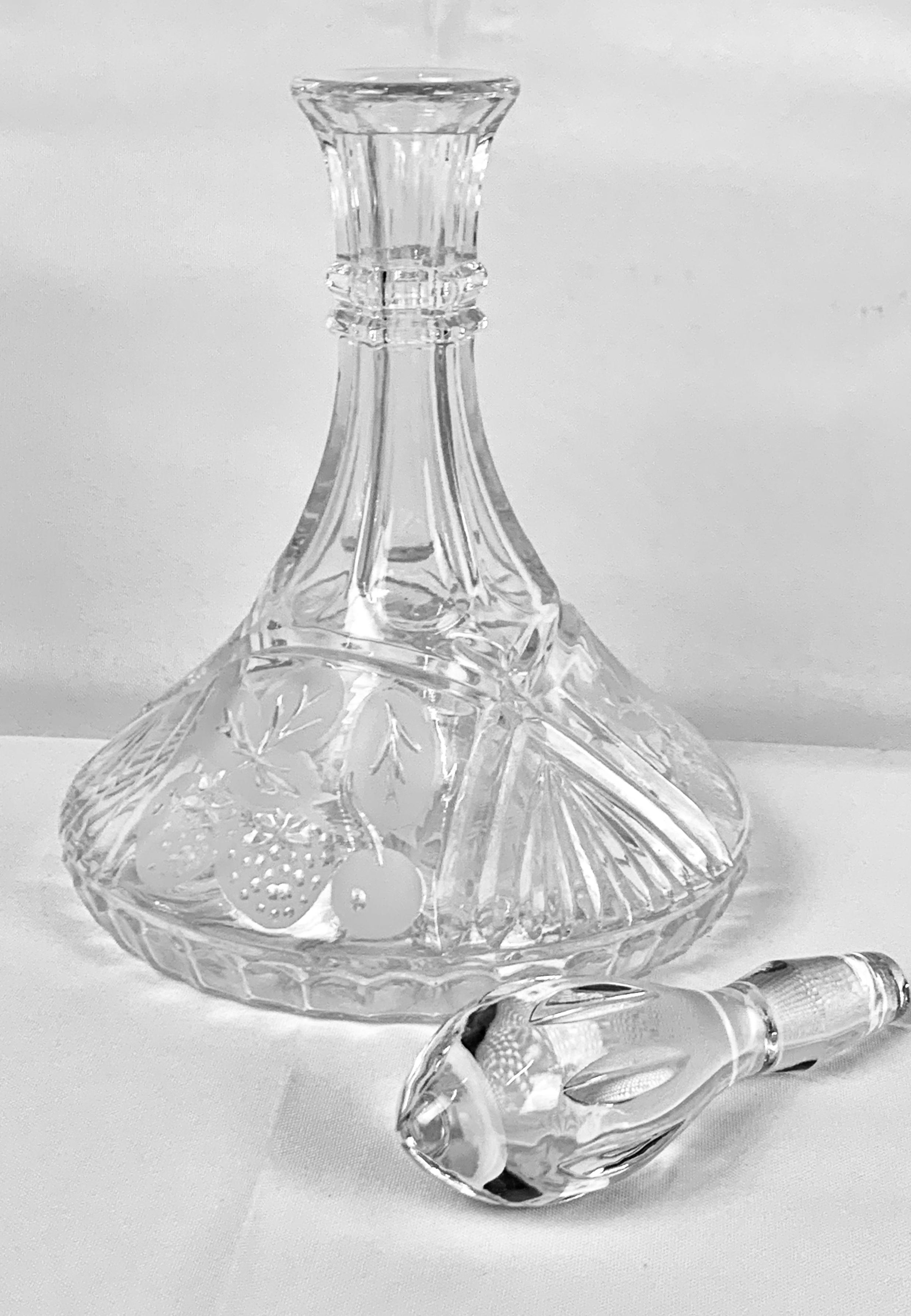 Handsome vintage decanter with etched strawberries and leaves on the base. The stopper is very clear and heavy. There are two grip rings at the top of the neck to prevent slipping. This decanter looks like it sat in a cabinet and never got used. It