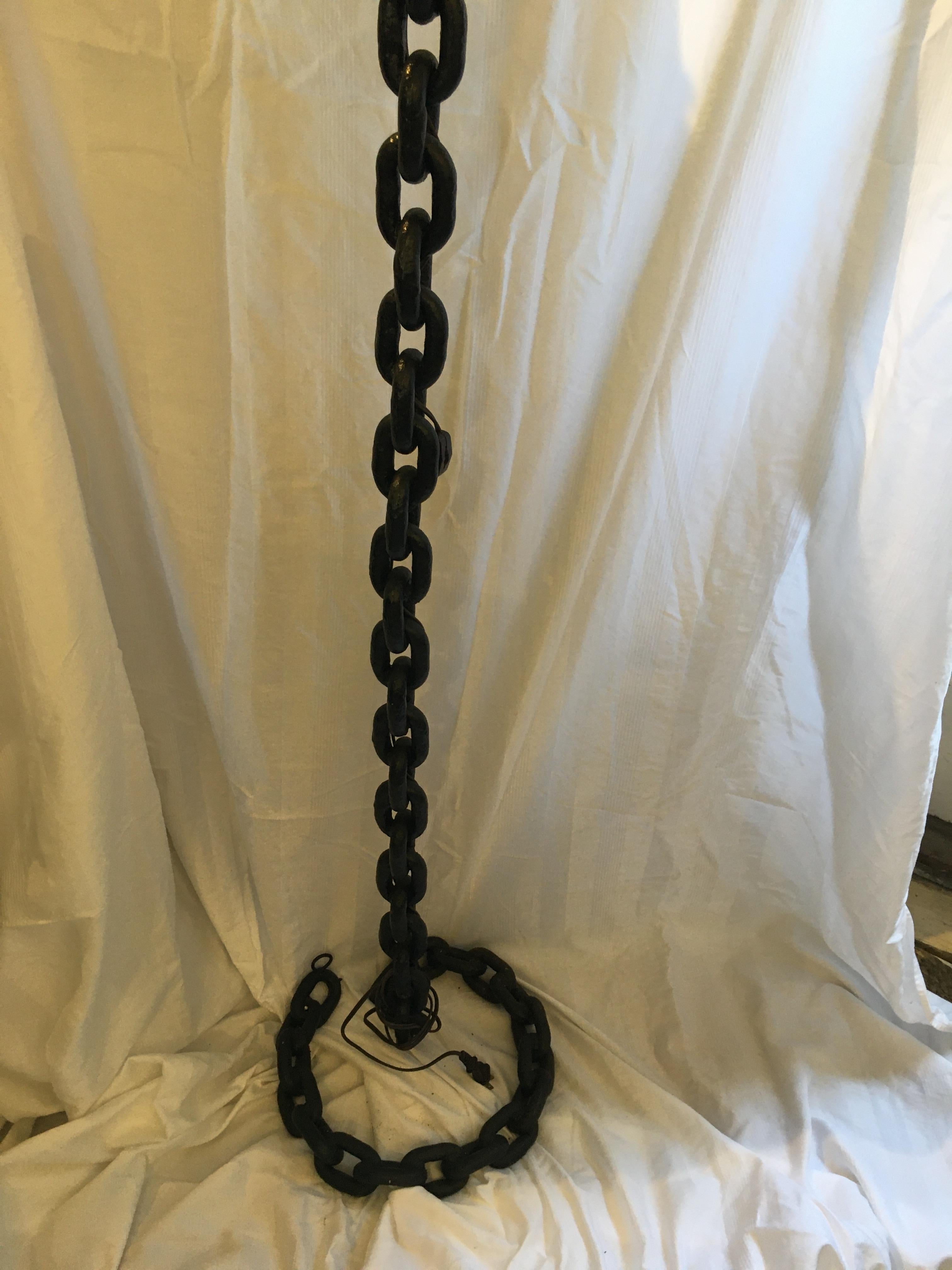 Repurposed ship’s 2” x 3” iron chain soldered to create the floor lamp and coiled into a circular base. Electrified for American use and takes one standard base light bulb and has a brass 9” harp for a spider lamp shade. (Not included).