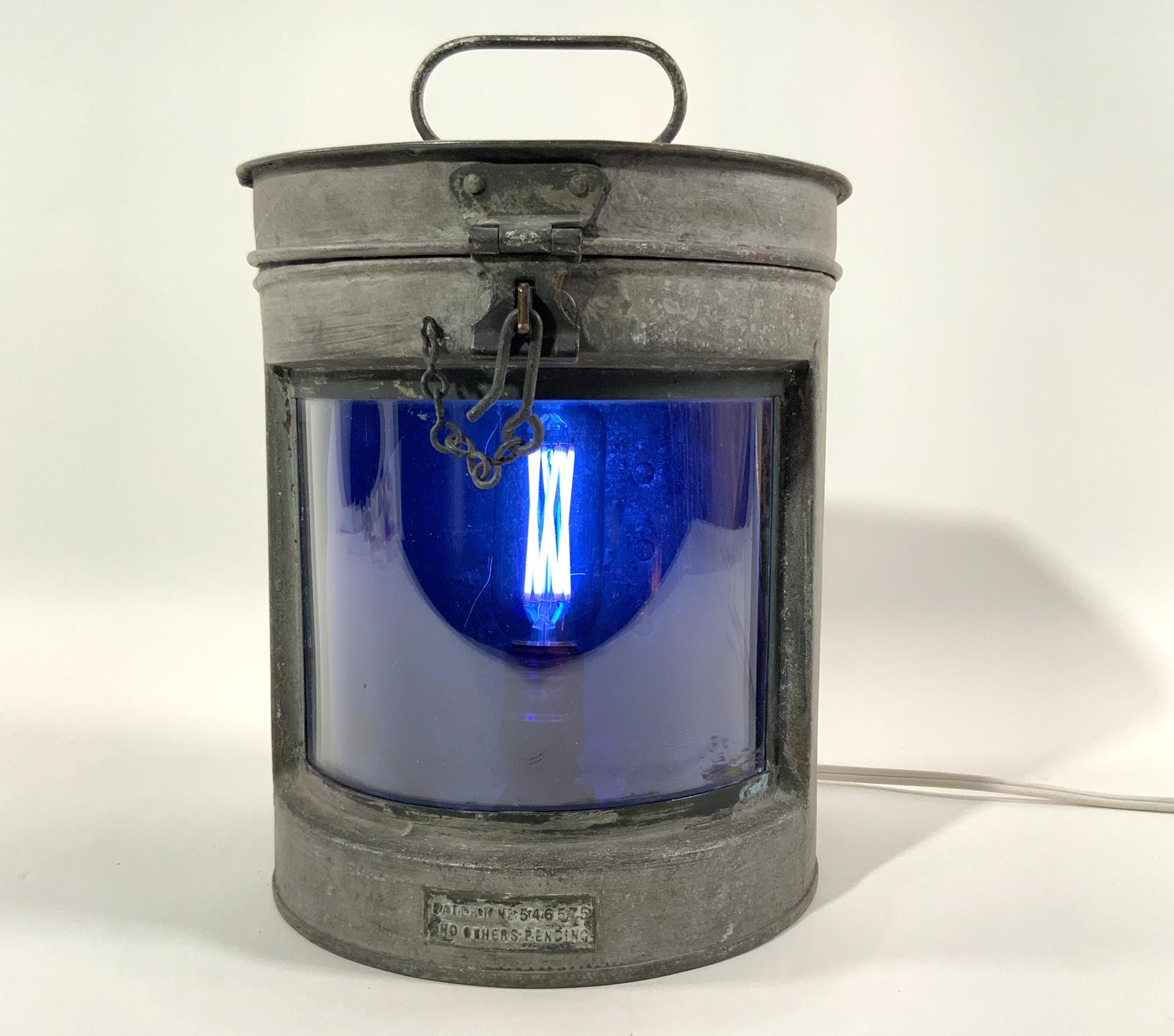 Meteorite ships lantern with curved cobalt blue lens, old original finish. Great patina. This is a choice antique lantern with hinged top and carry handle, embossed plate marked 