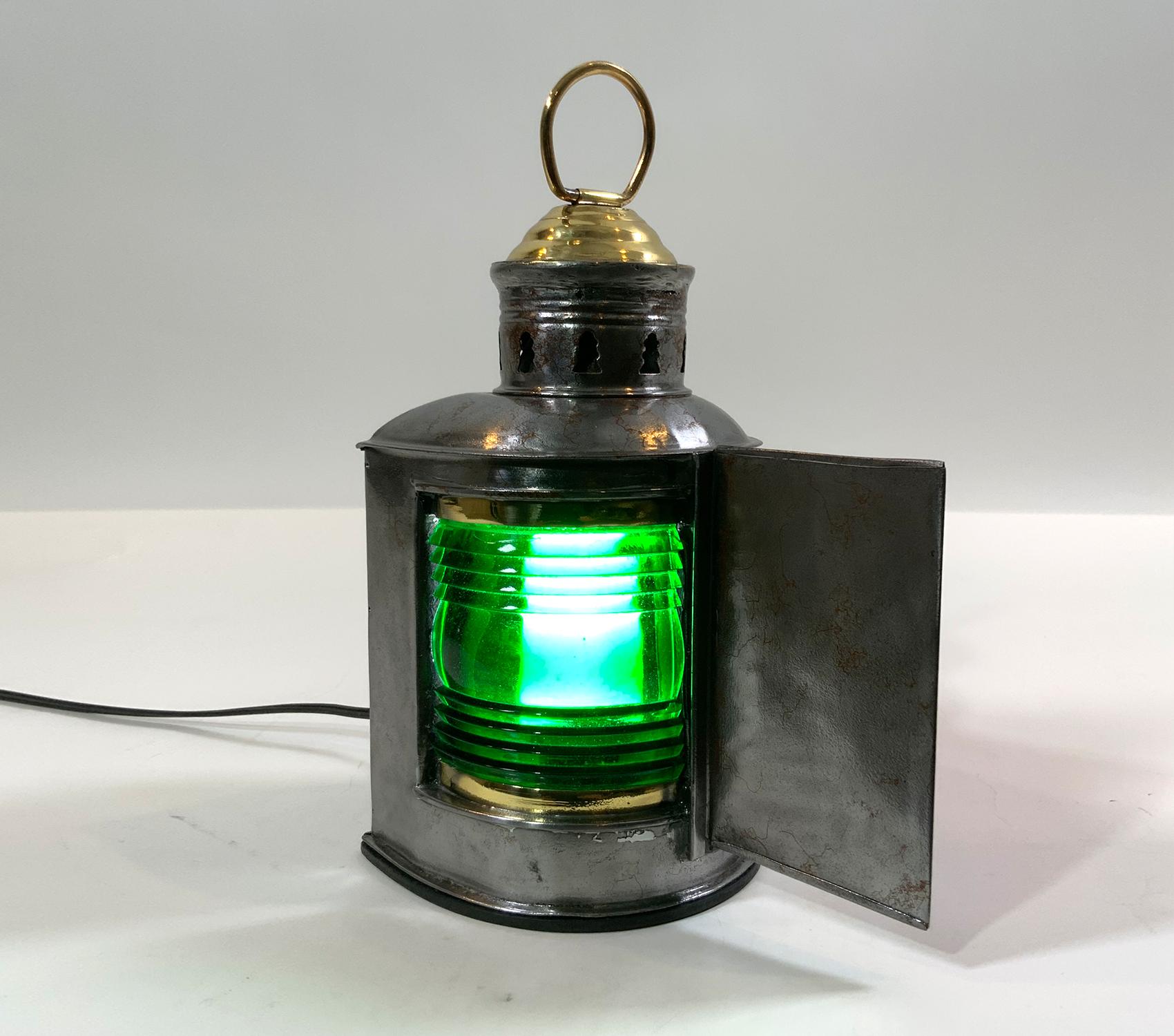 Steel boat bow lantern. Glass Fresnel lens in red and green. Steel case with brass cap. Also fitted with a carry ring. Wired with an electric socket for home use.

Weight: 2 LBS
Overall dimensions: 9” H x 5