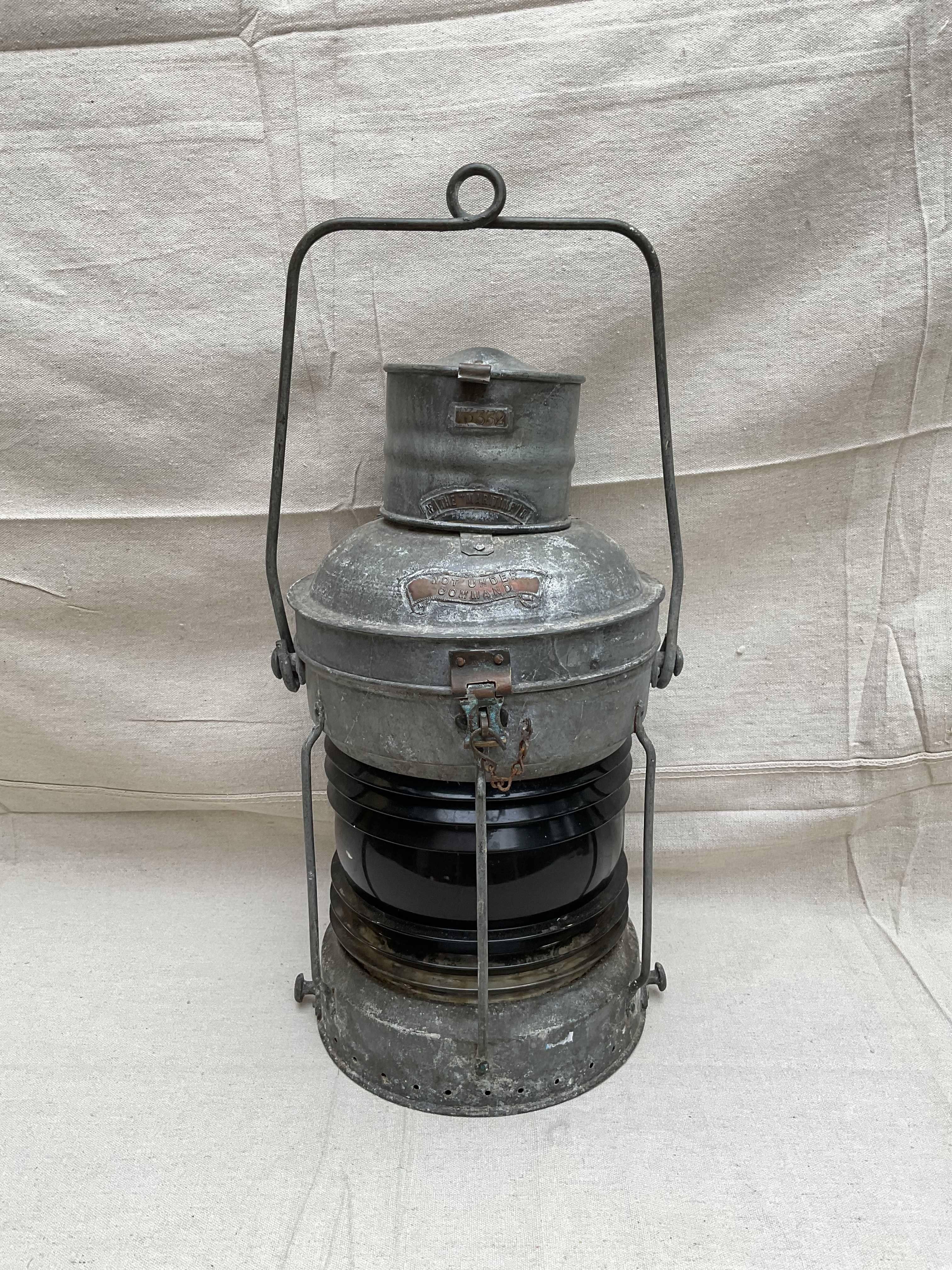 Ships not under command lantern with copper badges, rich red fresnel lens, protective bars, handles, etc. Remnants of the oil tank are present. Great patina on this nautical relic. 21x12 w/o handle