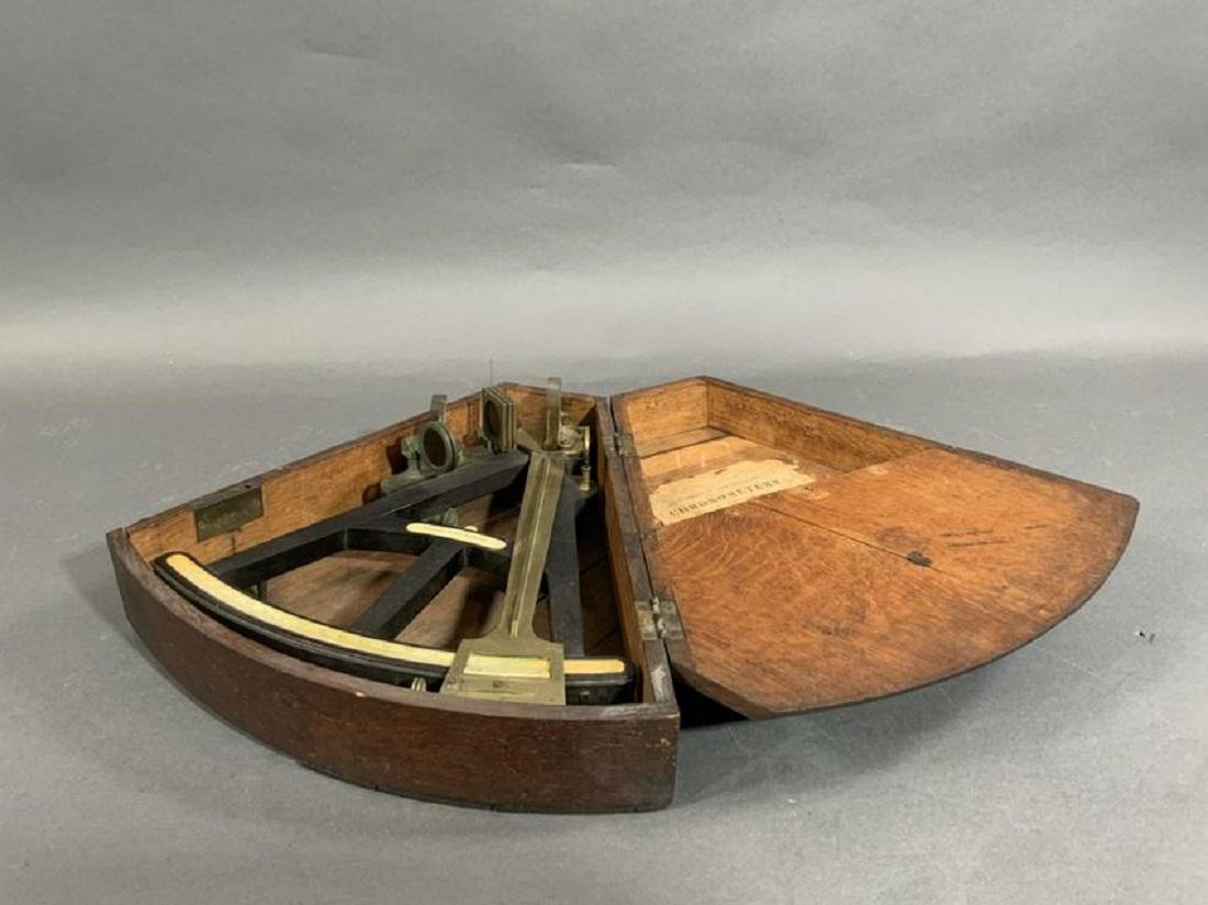 Ship's octant fitted to a step up kidney shaped box with merchants label from Eugene F Medinger, 115 Broad St New York. Schooner S.L. Baker is written in old ink. With filters, peepsight and mirror. Lid is missing a piece of wood.

Overall