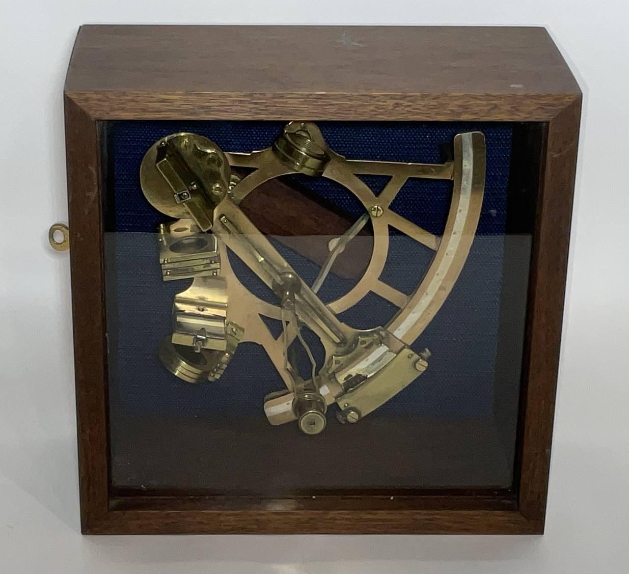 Custom maritime display with a solid brass ships sextant by John Lilley and Company of London. Mounted into a custom made mahogany box. The highly polished and lacquered sextant is mounted on a blue fabric. Glass front box. Sextant has colored glass