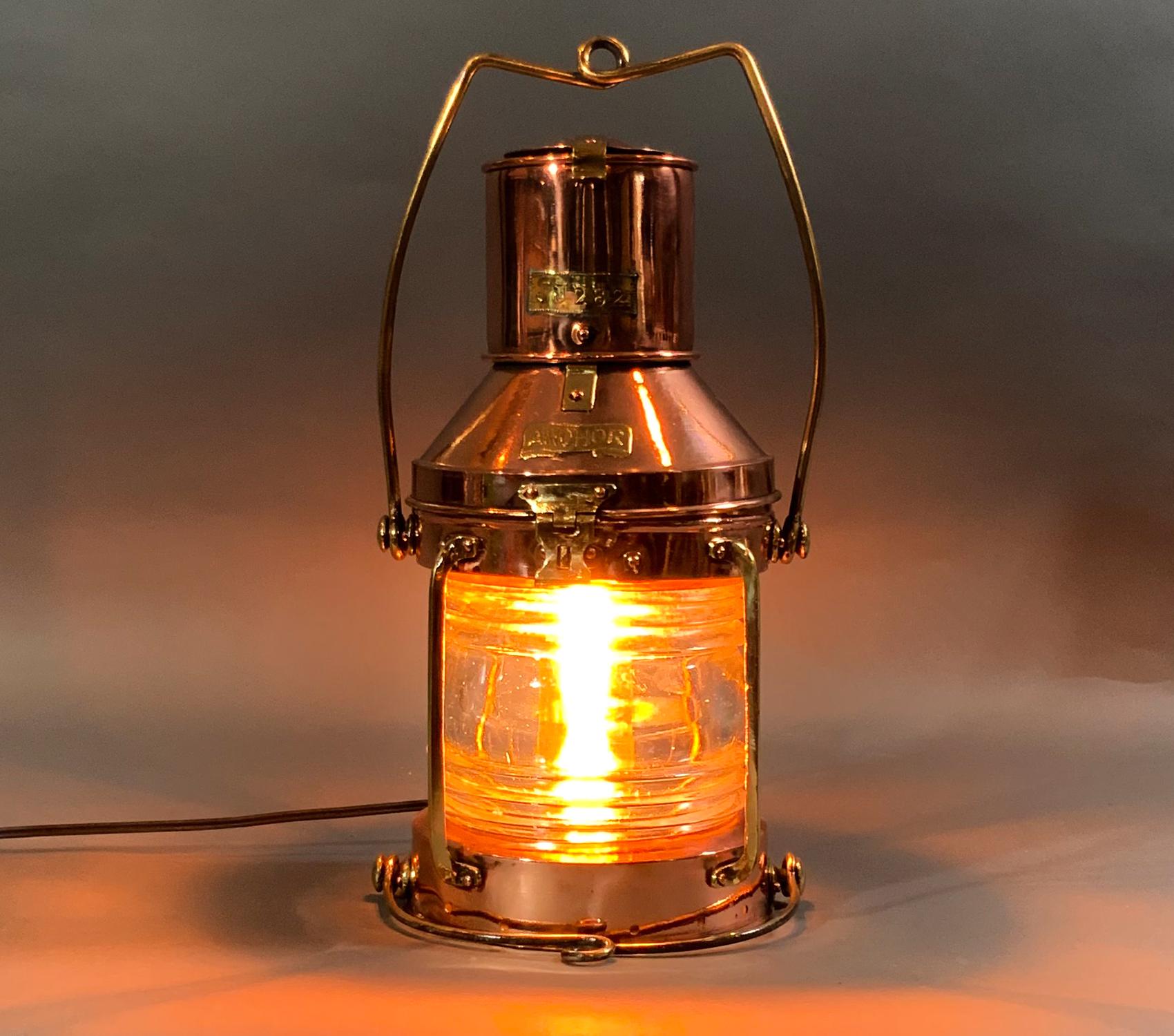 Ship lantern with solid copper case, brass trim, hoisting and bale handle, etc. Highly polished and lacquered with glass Fresnel lens. Recently rewired with a new power cord for home use. Brass makers badges. 

Weight: 7 LBS
Overall dimensions: