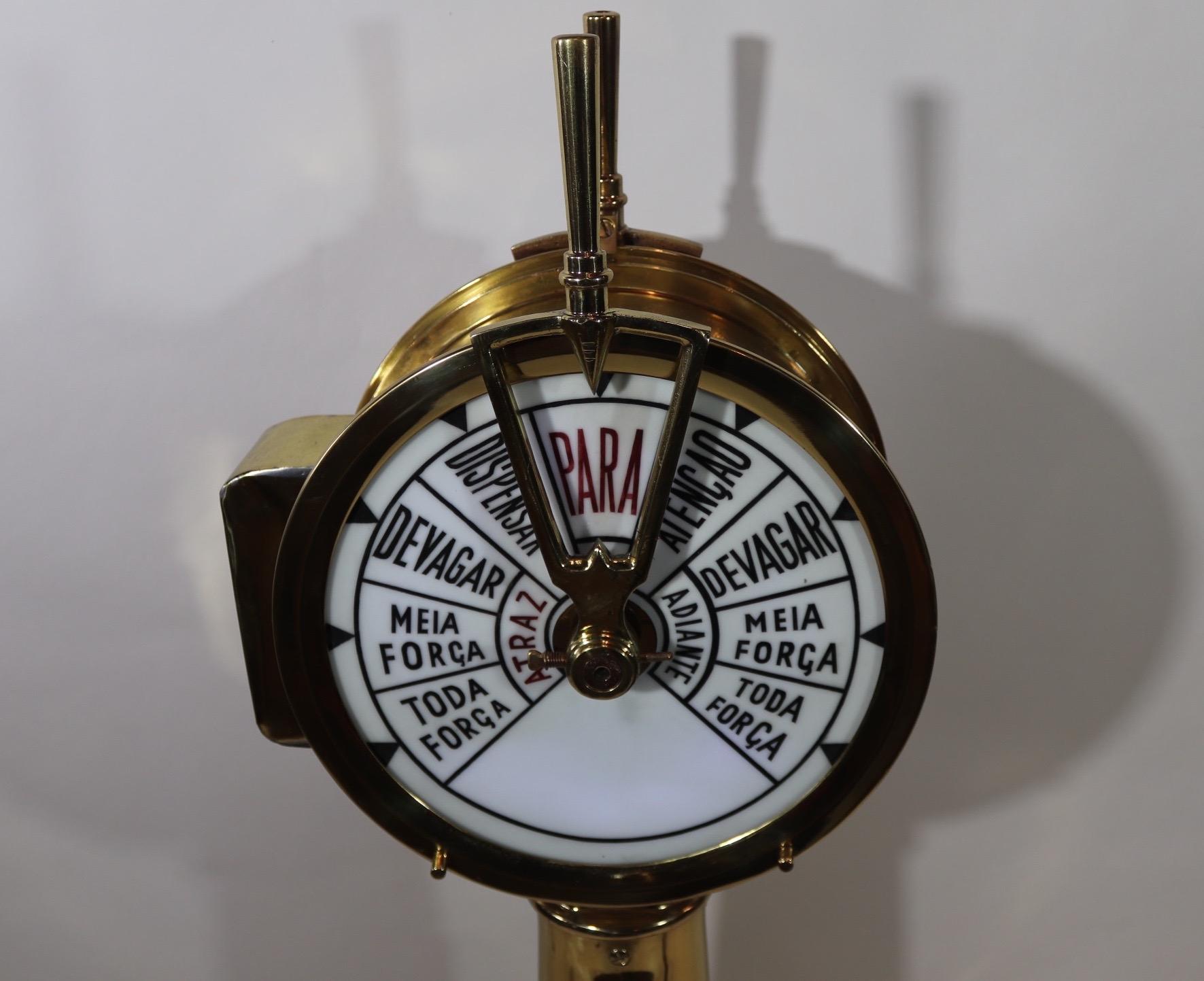 Splendid ships engine order telegraph that has been meticulously polished and lacquered. The faceplate commands are in Portuguese. The inside has been illuminated by us to make the faceplates flow. Fitted to a custom wood base with varnished finish,