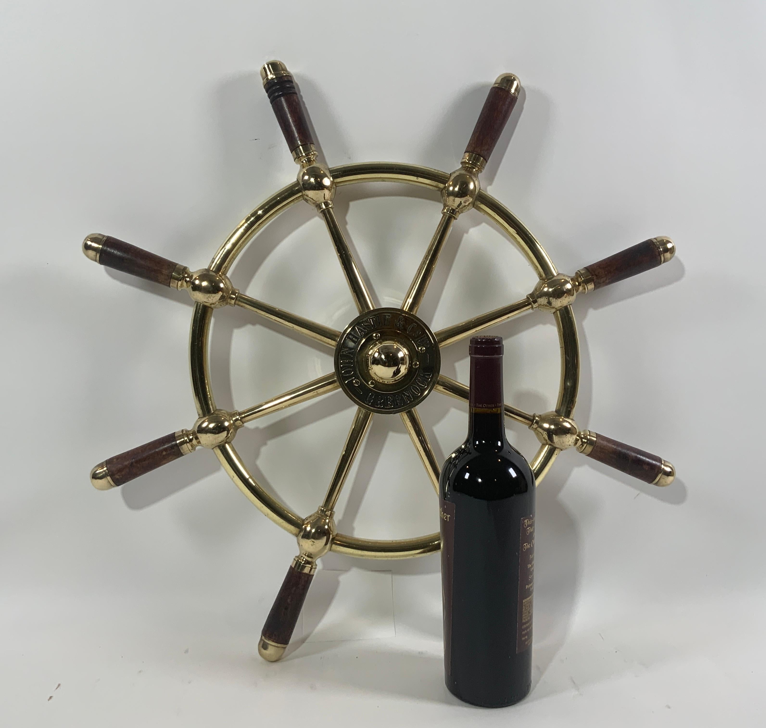 Very nice antique solid brass ships wheel that has been highly polished and lacquered. The hub has deeply engraved makers name 